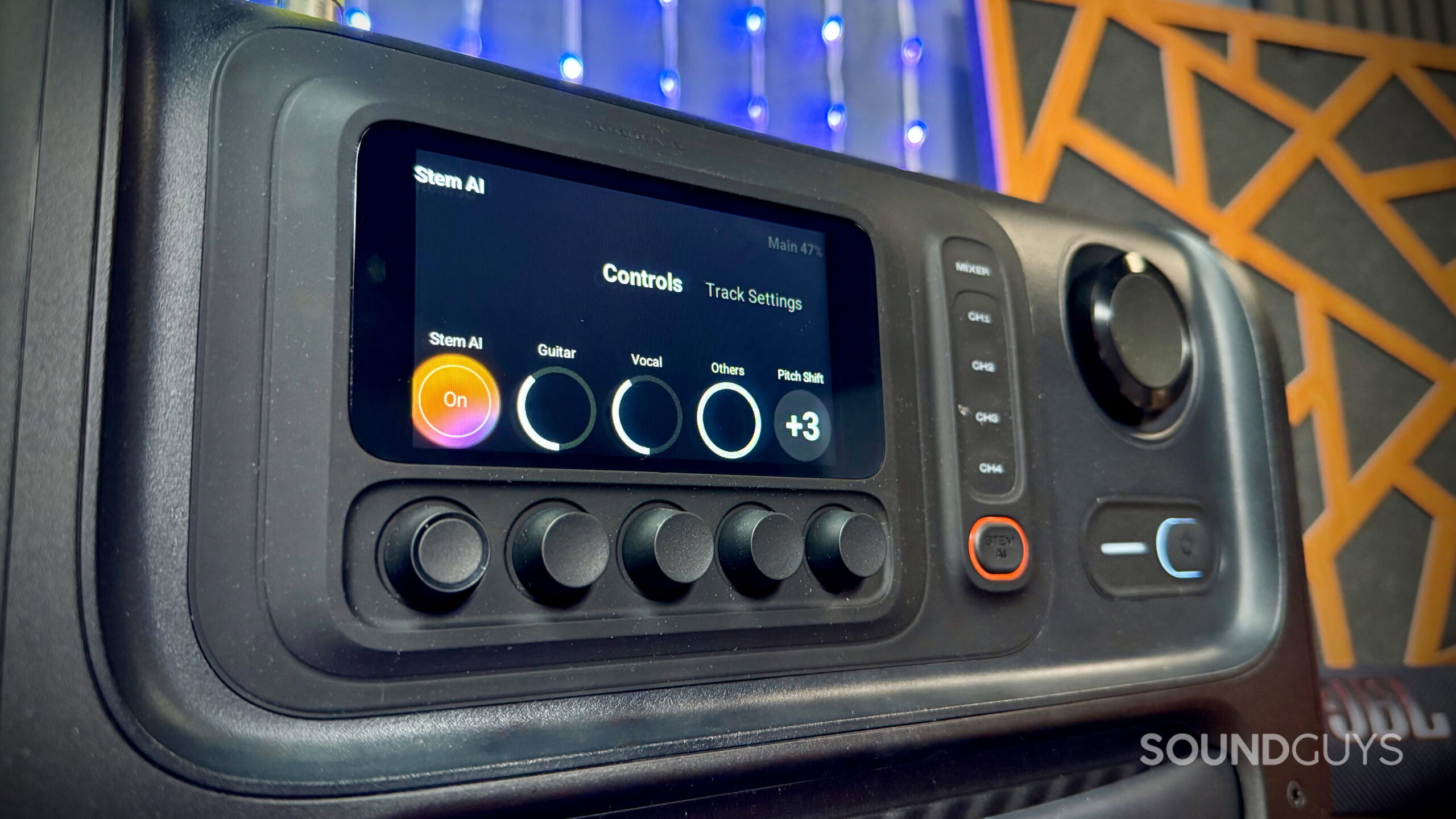 JBL BandBox Trio display showing Stem AI controls for guitar, vocal, and other track levels, as well as pitch shift adjustments.