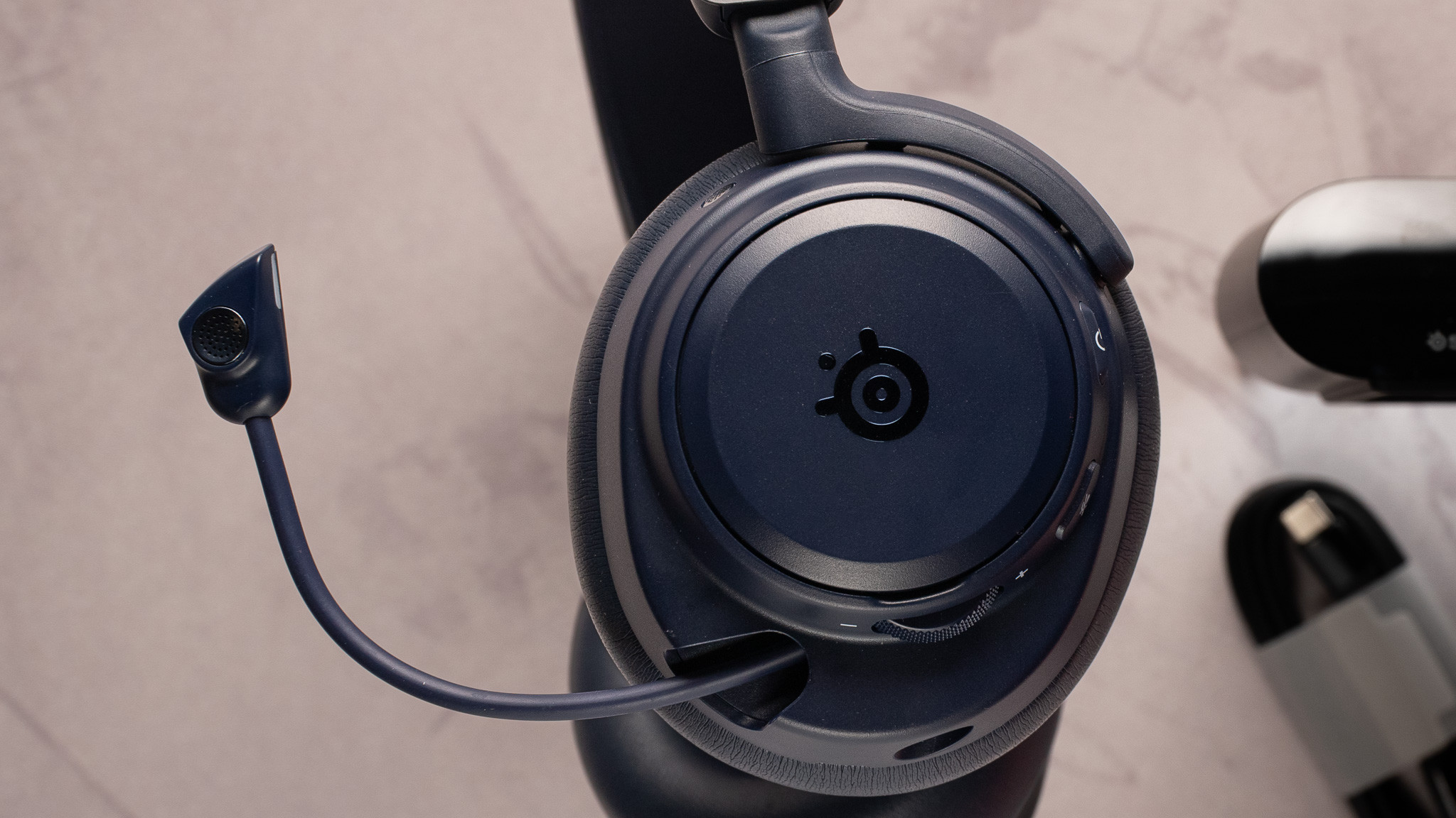 SteelSeries Arctis Nova Pro Omni microphone close up SteelSeries Arctis Nova Pro Omni close up of the earcups with detail for the embossed logo.