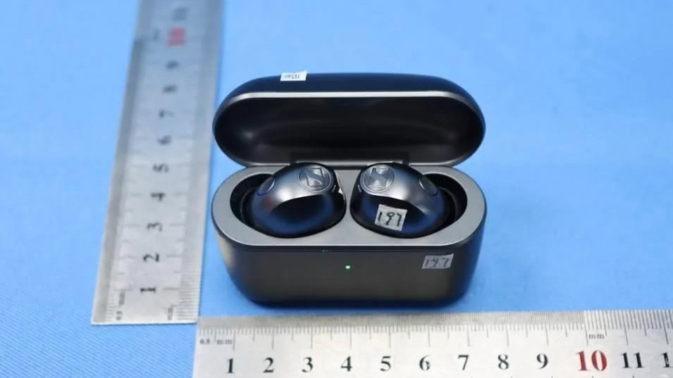 Leaked Sennheiser Momentum True Wireless 5 earbuds seated in their open hard-shell charging case with a green charging indicator LED visible