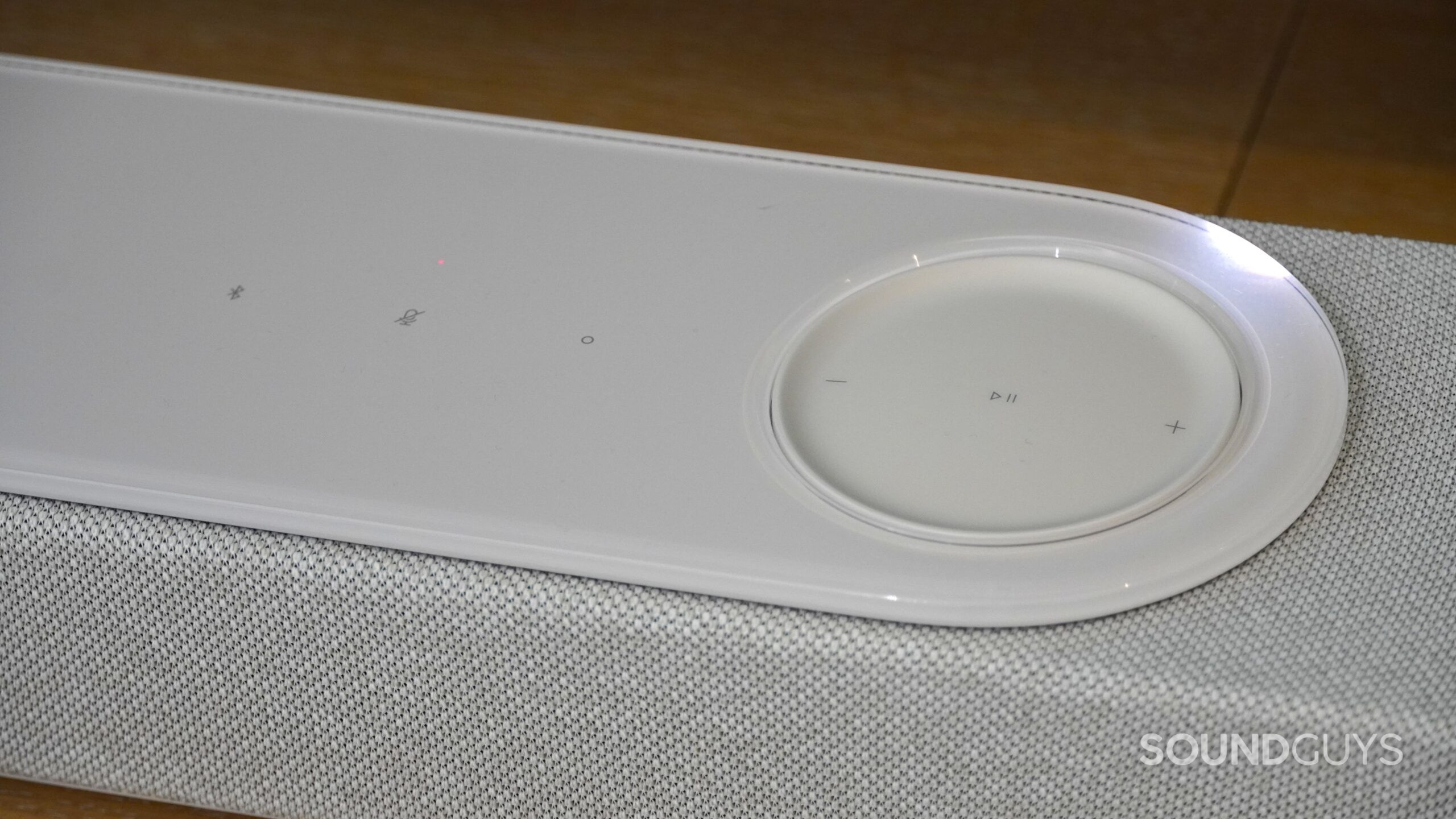 Close-up of Bose soundbar top panel showing touch controls for volume, playback, and microphone mute.