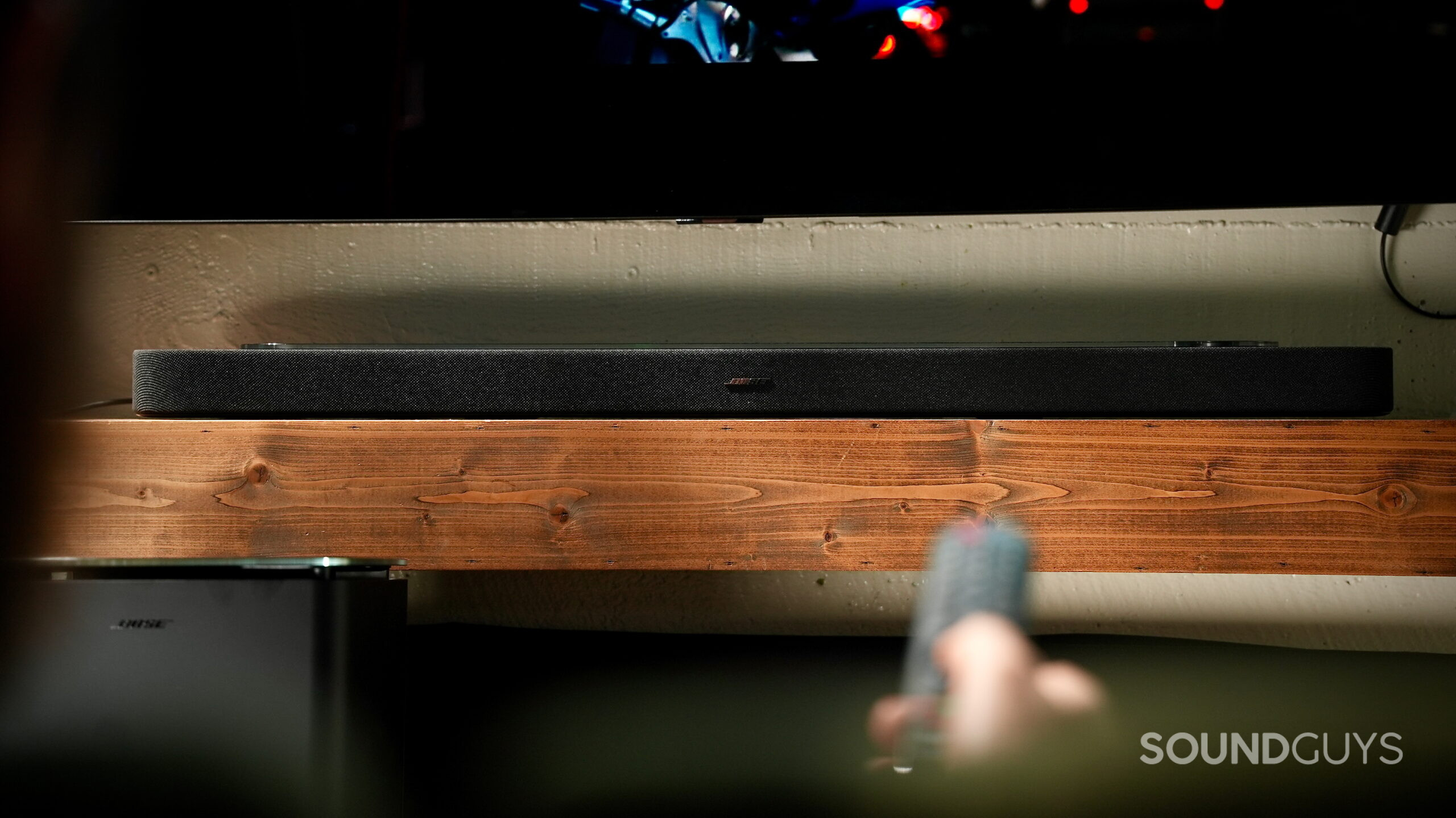 Front view of the Bose Lifestyle Ultra Soundbar beneath a TV