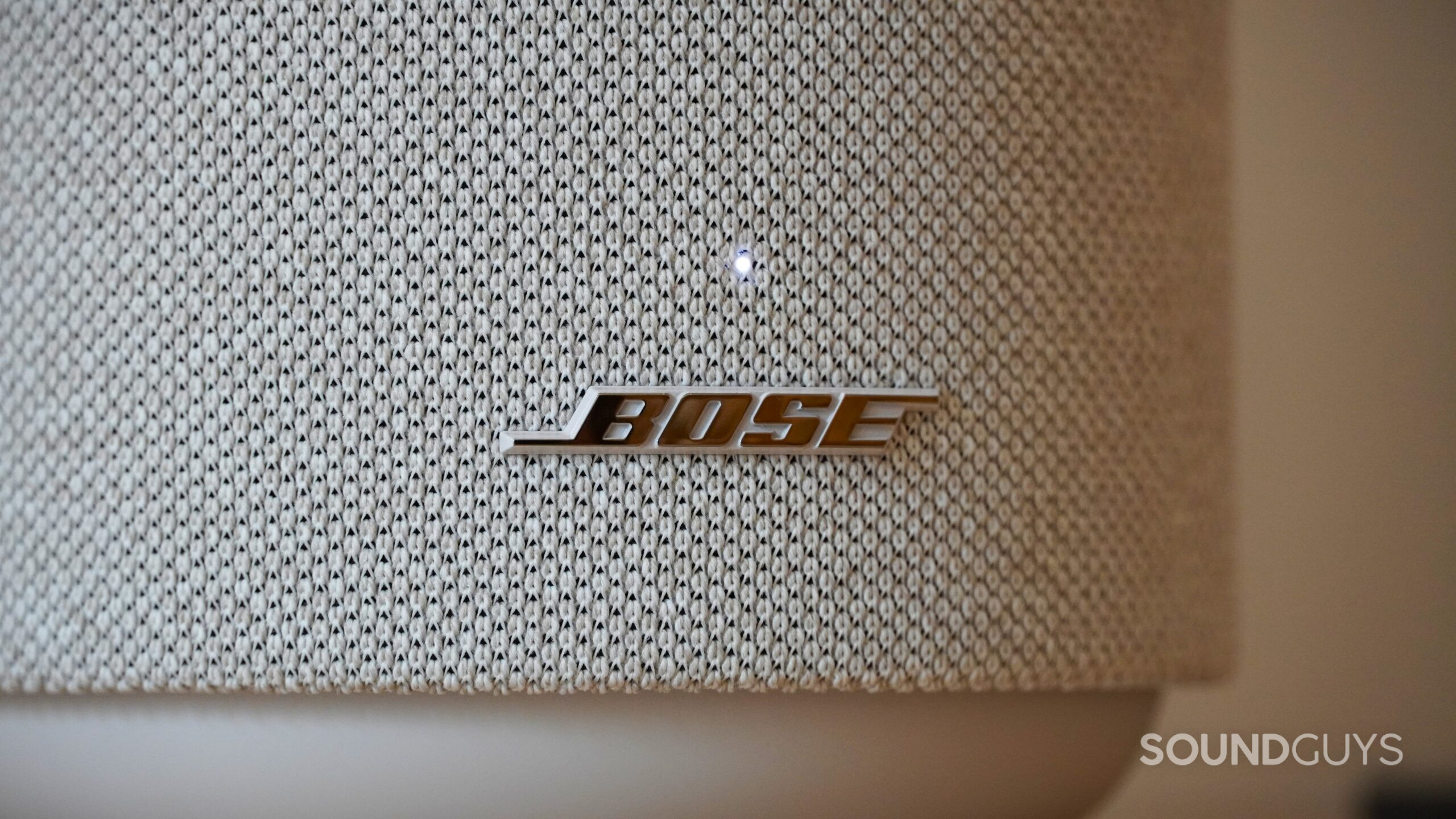 Close-up of Bose logo on a fabric speaker grille.