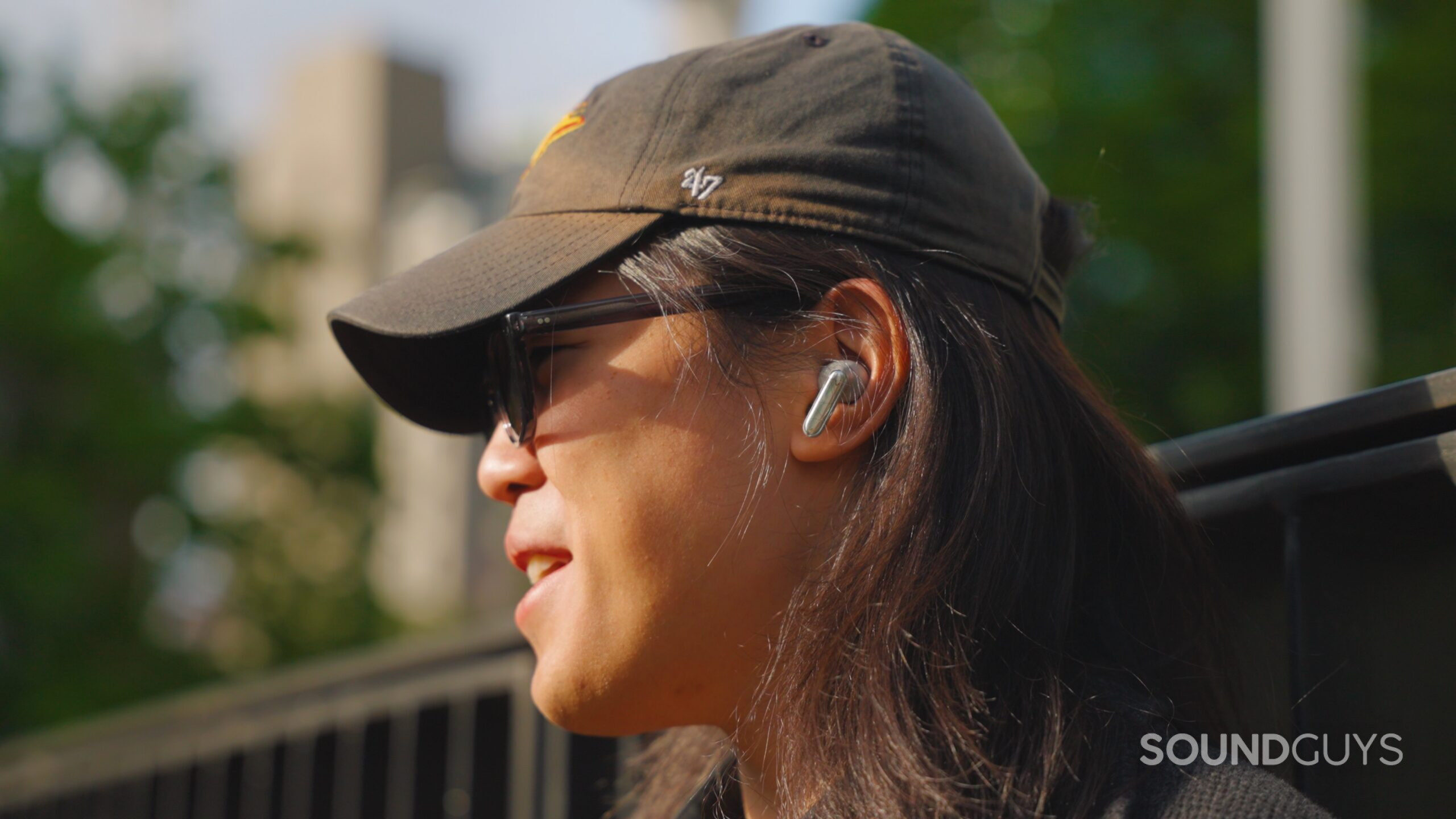 A man wears Viaim RecDot earbuds while outdoors.