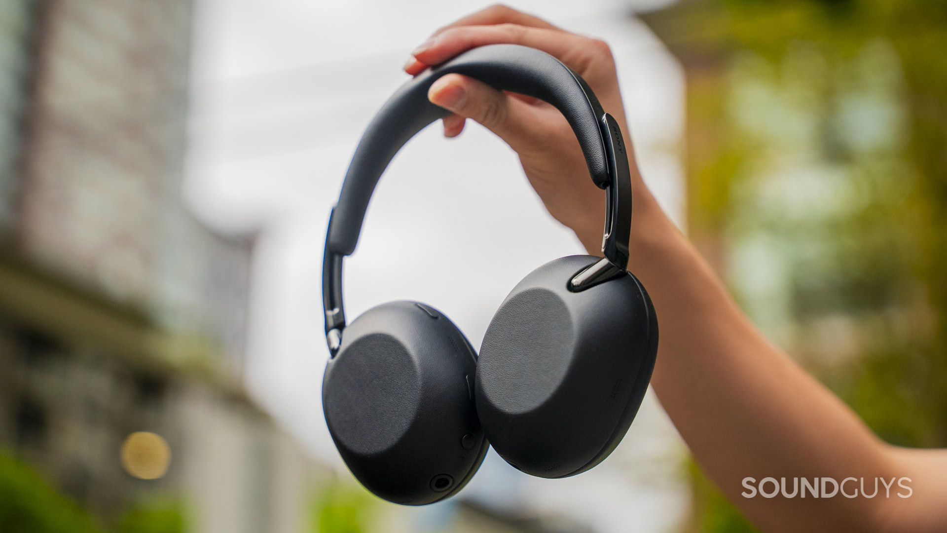 holding the sony the collexion headphones up in the air