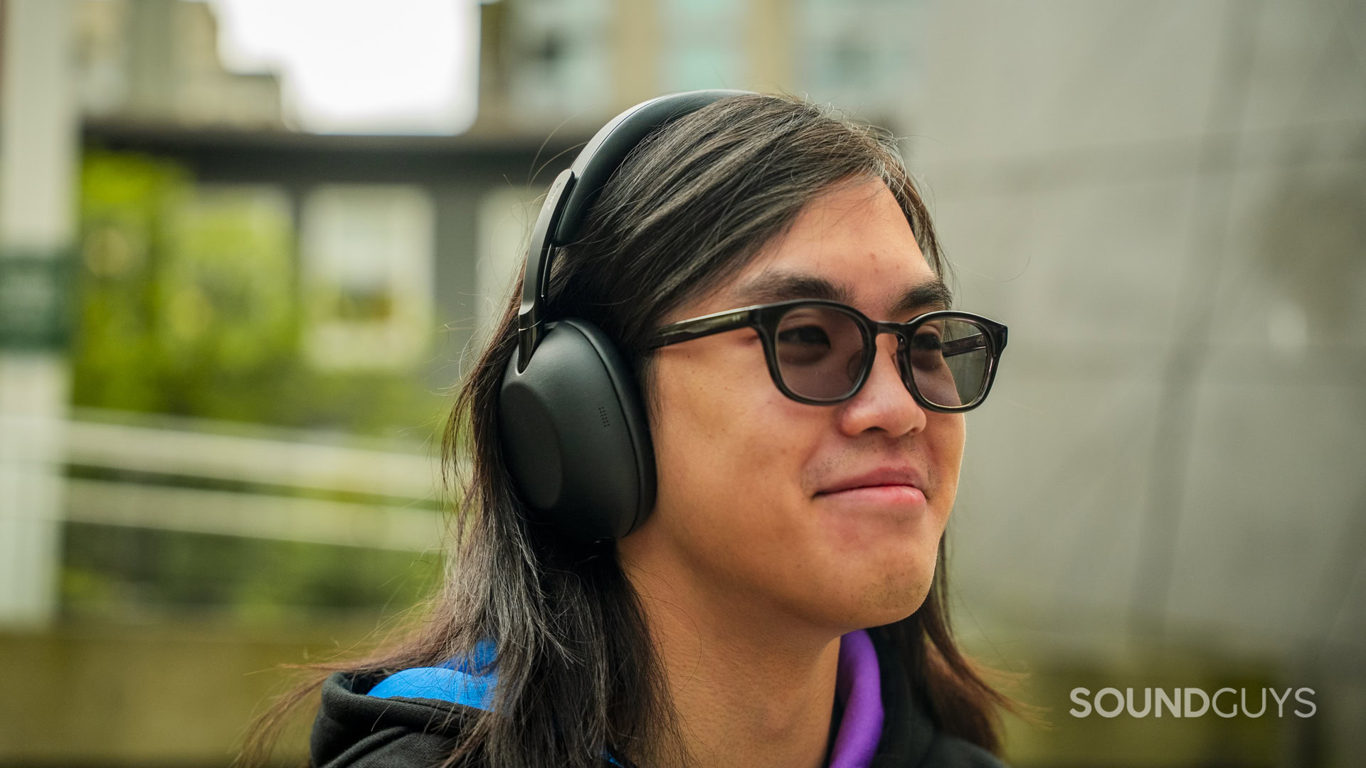 a man wearing the sony 1000x the collexion headphones outside