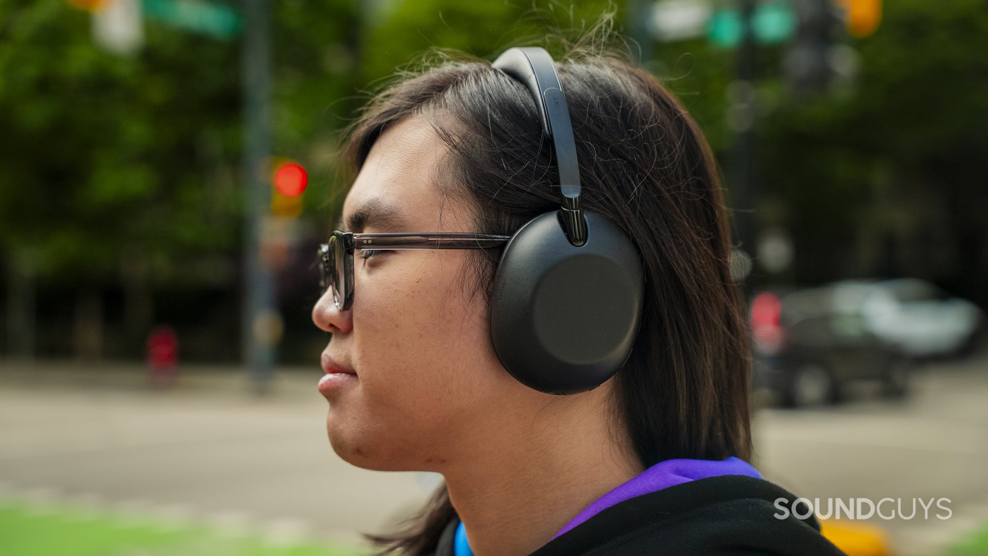 a man listening to the sony 1000x the collexion headphones outdoors