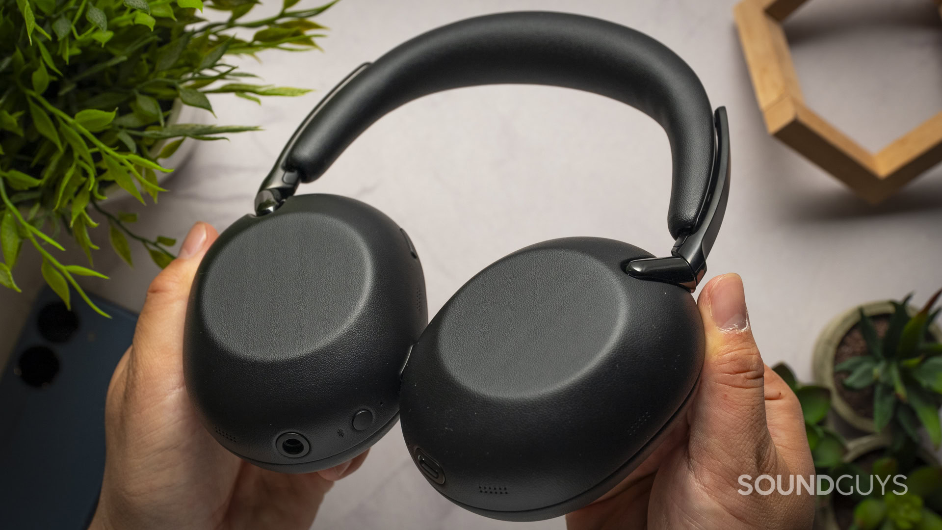 sony 1000x the collexion black headphones in hand