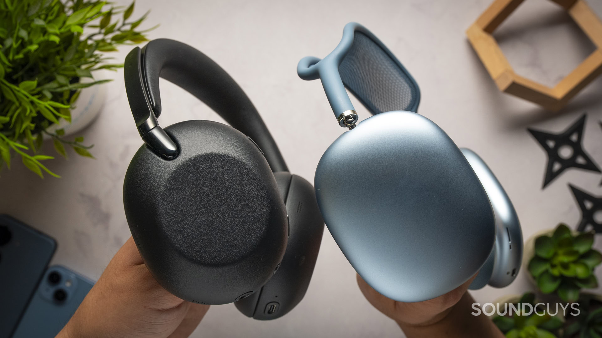 Sony WH-1000XX The Collexion Vs-9 Holding the Sony 1000X The Collexion (Black) and the Apple AirPods Max 2 (Blue) side by side.