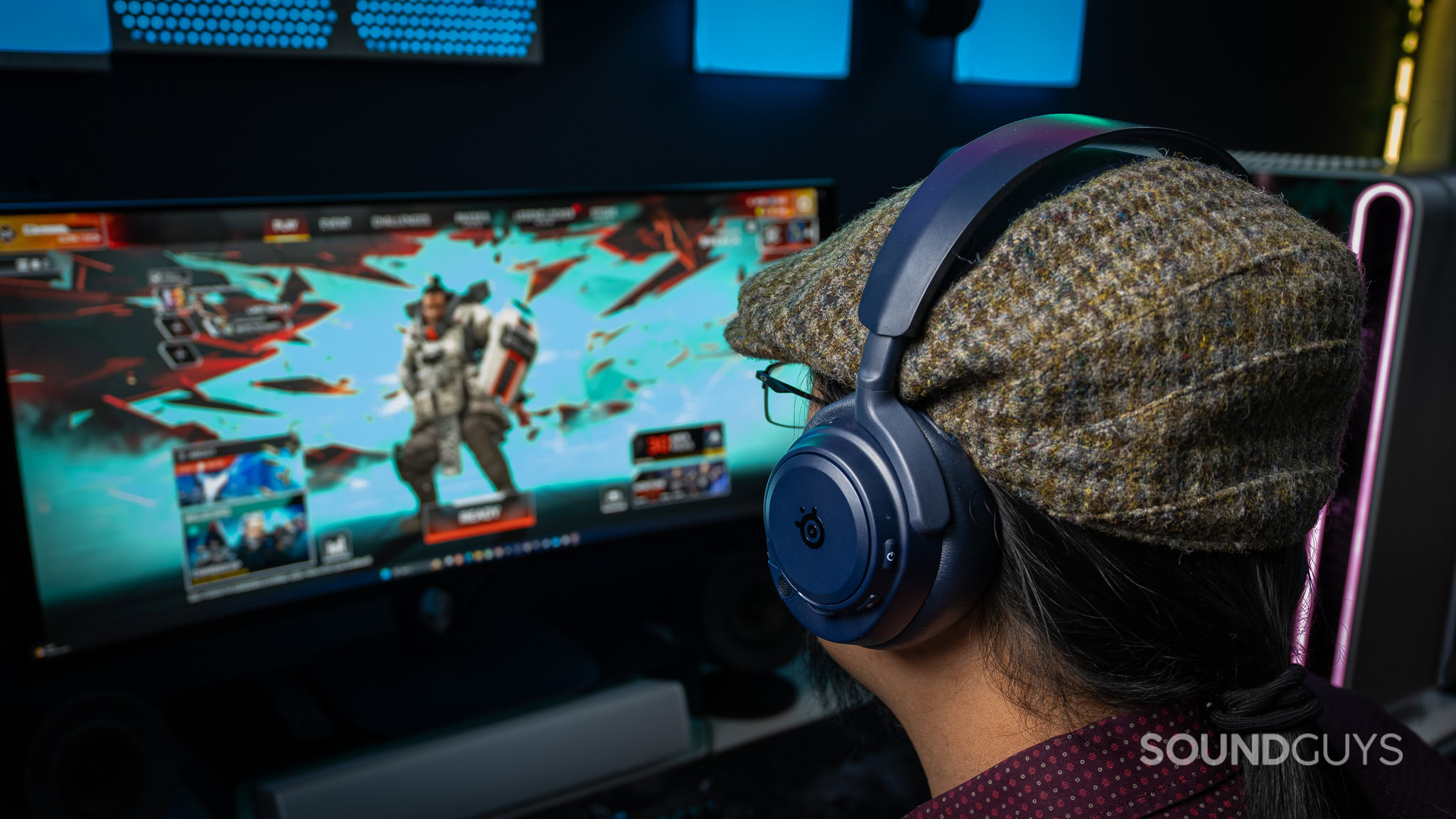 SteelSeries Arctis Nova Pro Omni gaming worn SteelSeries Arctis Nova Pro Omni with a man looking at a screen while a game is being played.