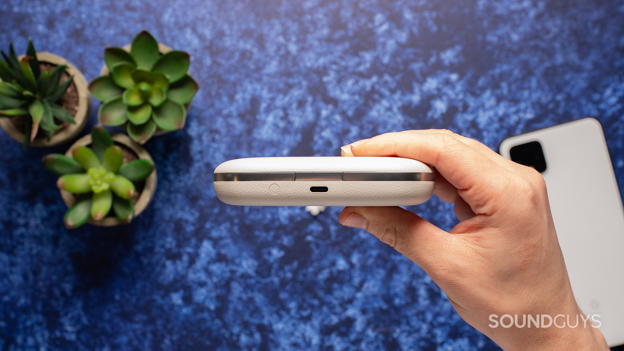 Hand holding Viim OpenNote charging case.