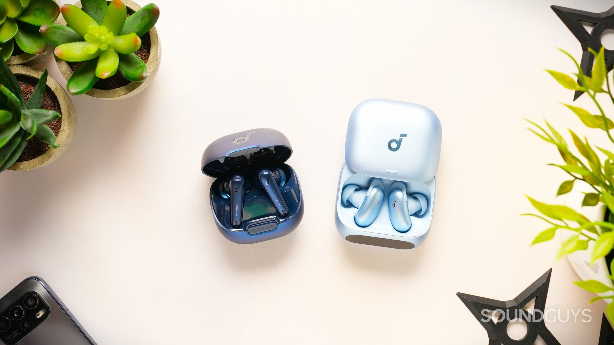 anker soundcore liberty 4 nc and liberty 5 pro earbuds on table with case open