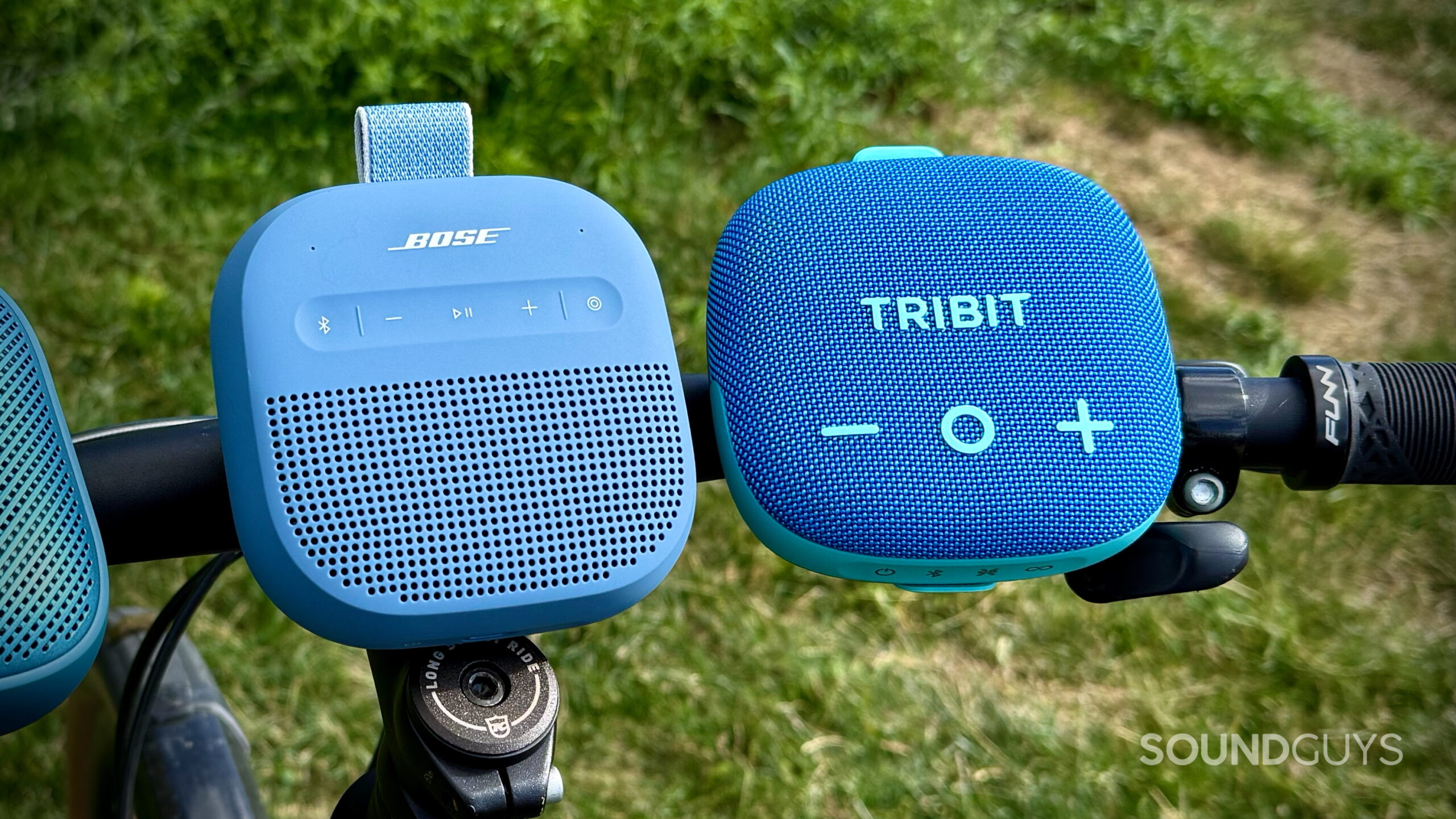 Bose SoundLink Micro (2nd Gen) alternatives - 3 (2) The Bose SoundLink Micro 2nd Gen and Tribit StormBox Micro are placed on bike handlebars.