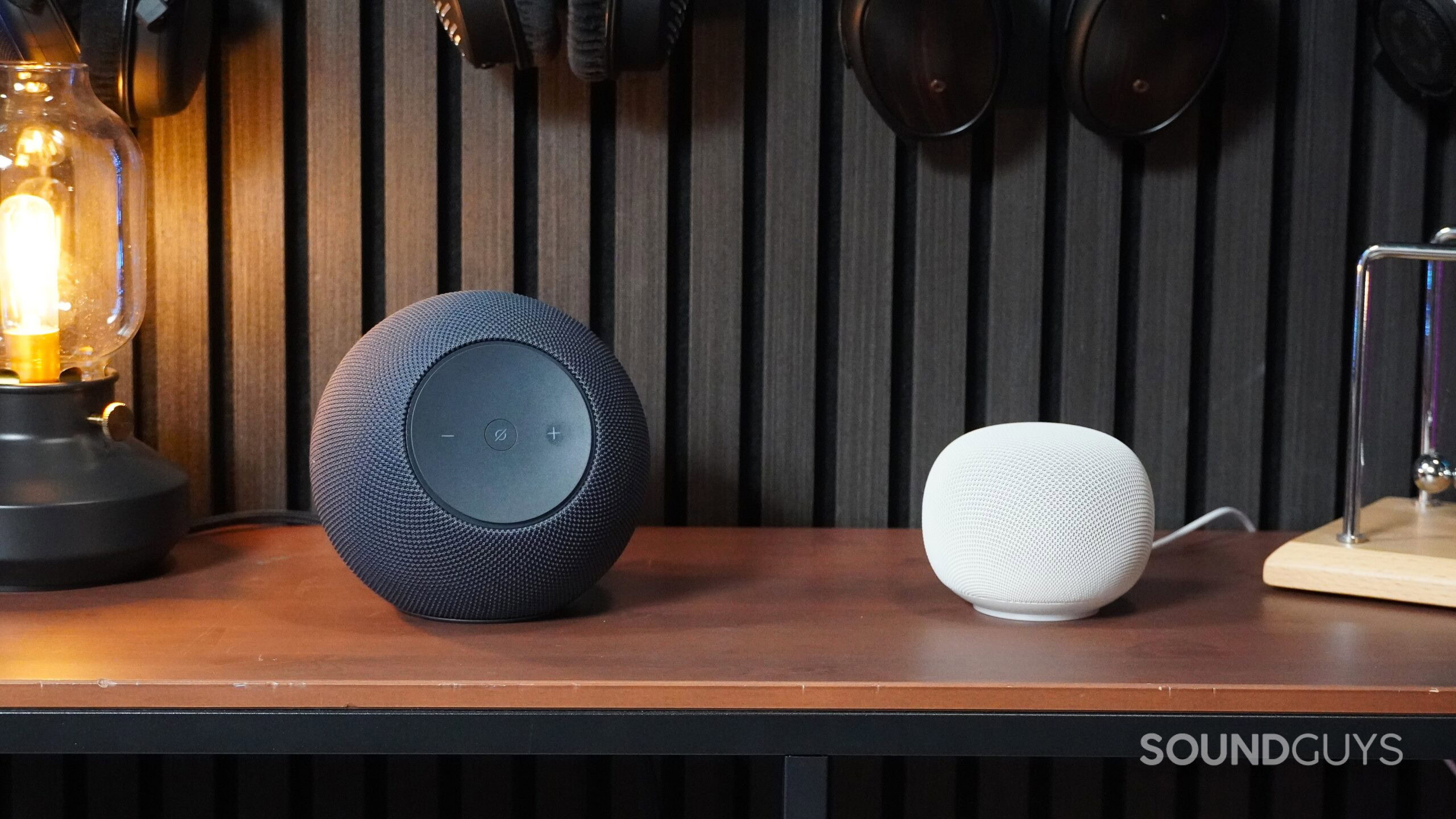 amazon echo studio vs google home speaker amazon echo studio and google home speaker on a desk