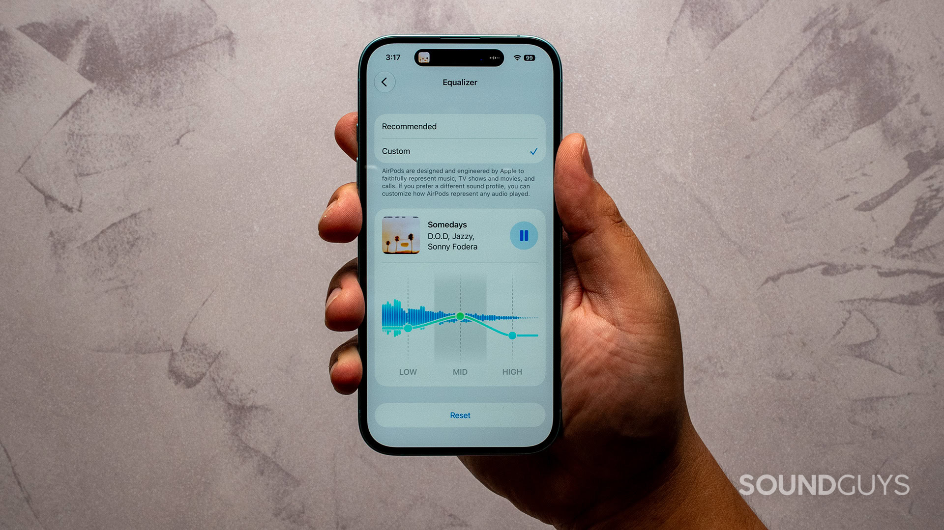 apple custom eq_airpods pro 3_in hand A hald holding an iphone showing the airpods custom equalizer settings