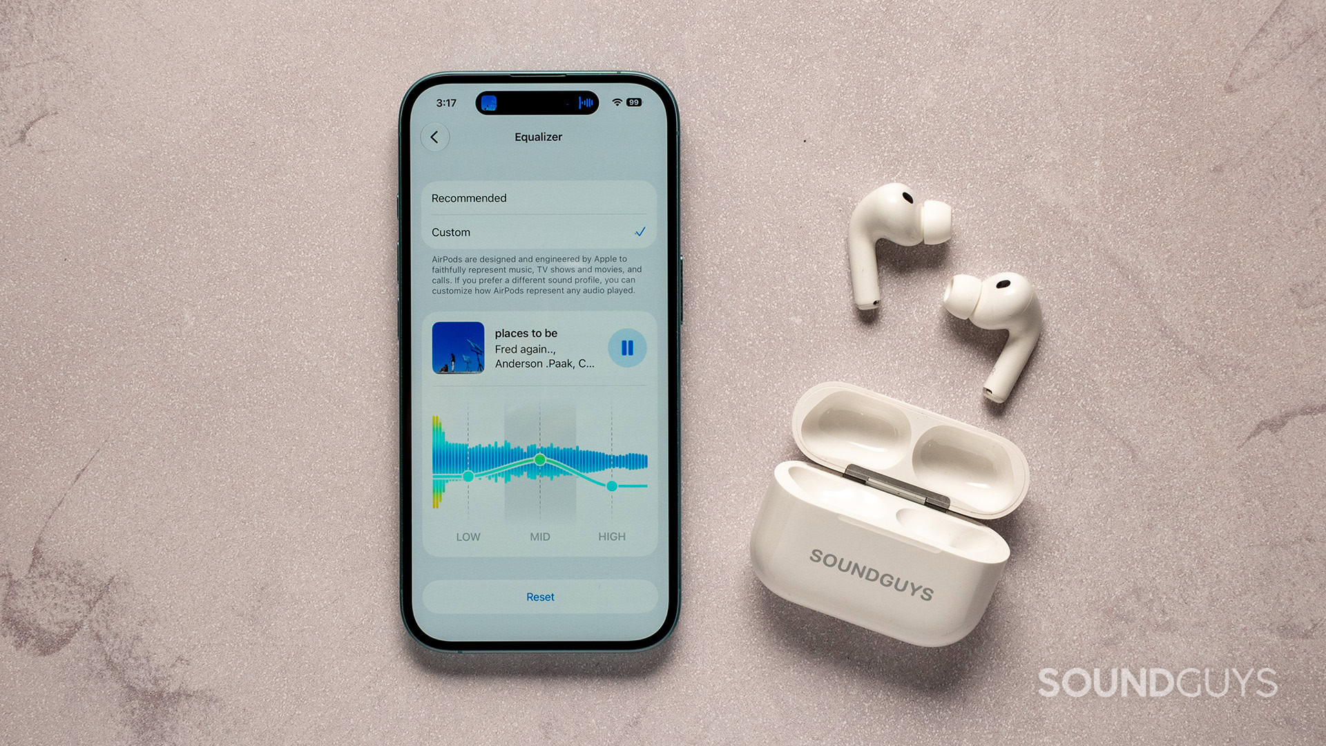 apple custom eq_airpods pro 3_on table airpods pro 3 beside the custom eq settings on iphone