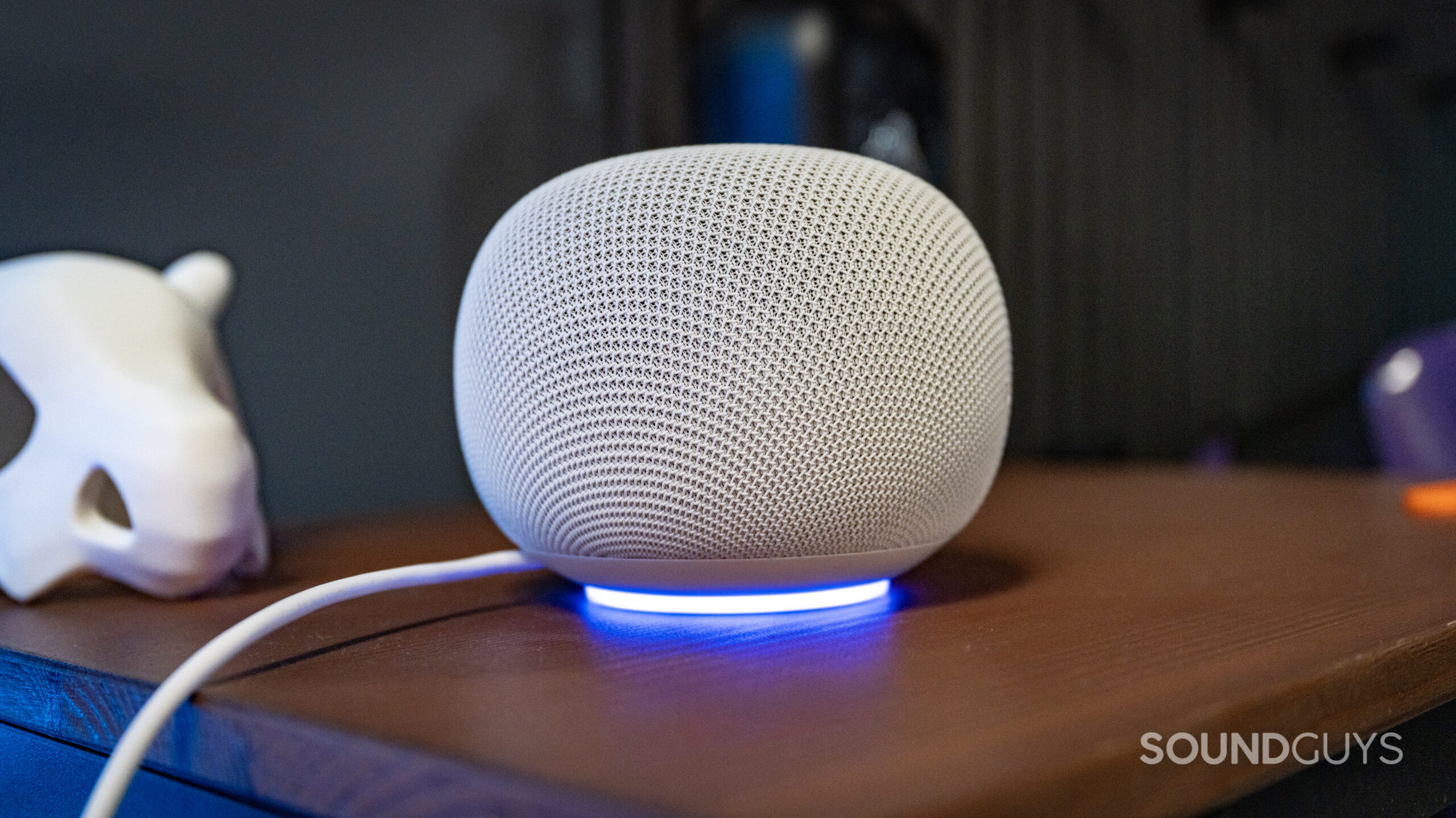 google home speaker on wooden shelf with ring light activated