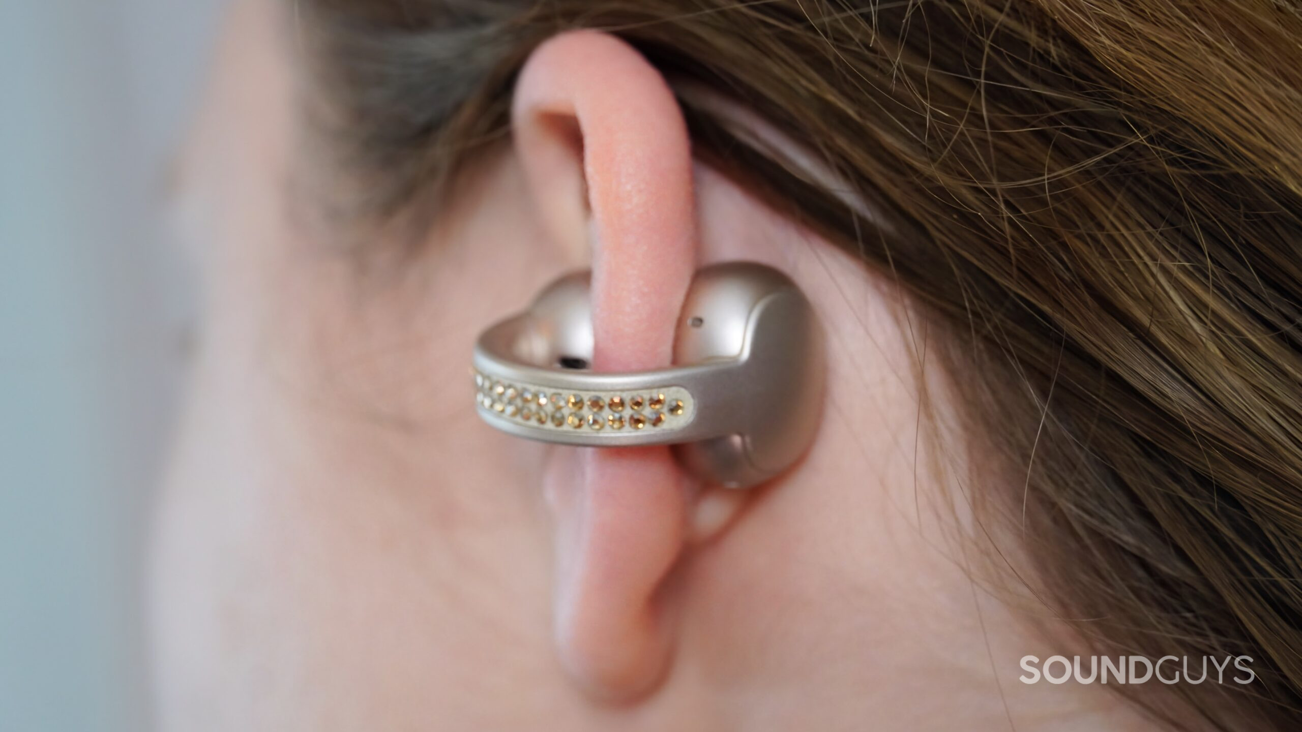 The Moto Buds Loop clipped on an ear lobe.