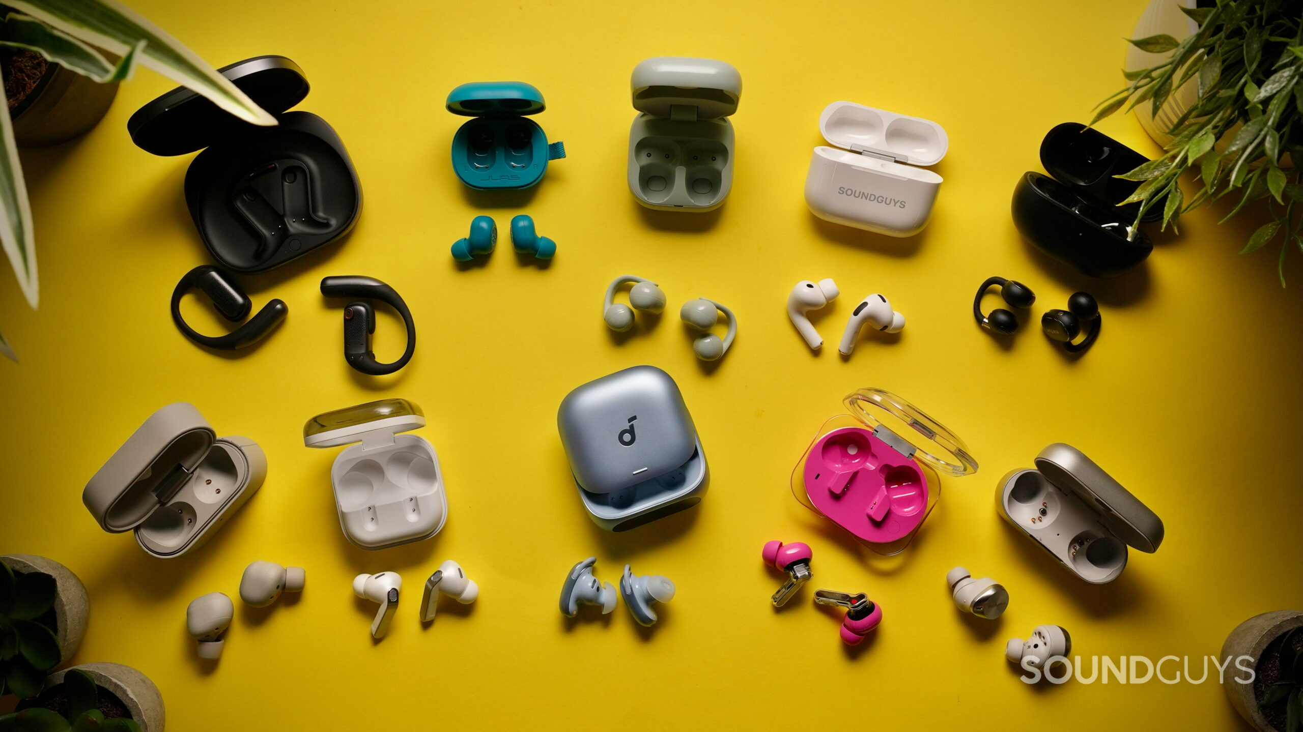 Earbuds buying guide hero - 1 Top down photo of many pairs of earbuds, as if a listener was forced to choose a single pair.