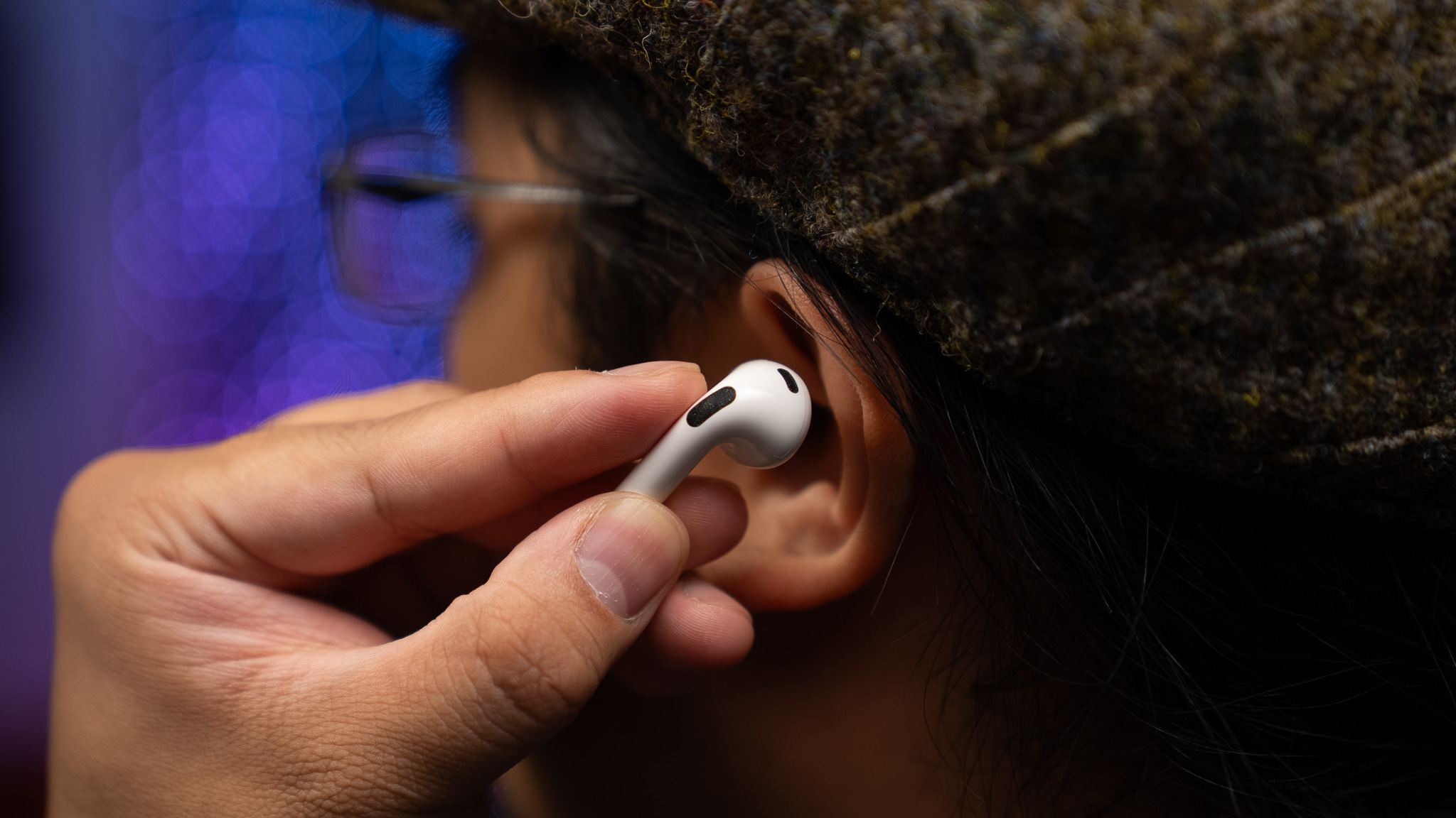 Inserting earbud into ear