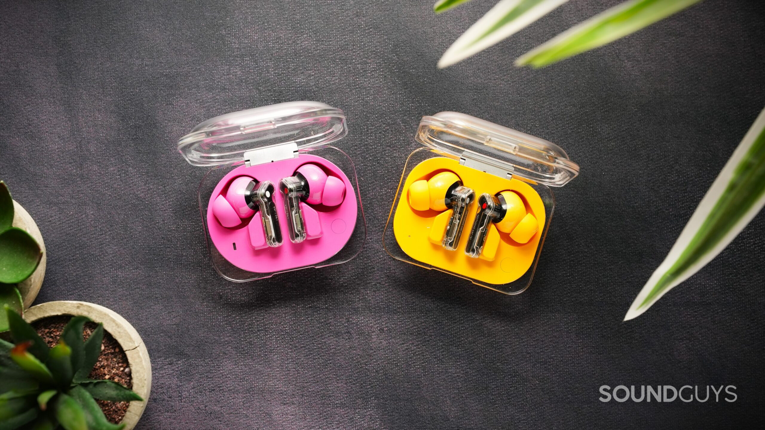 Nothing ear 3a vs Ear a (2) Nothing ear 3a in pink vs Ear a in yellow, earbuds on surface