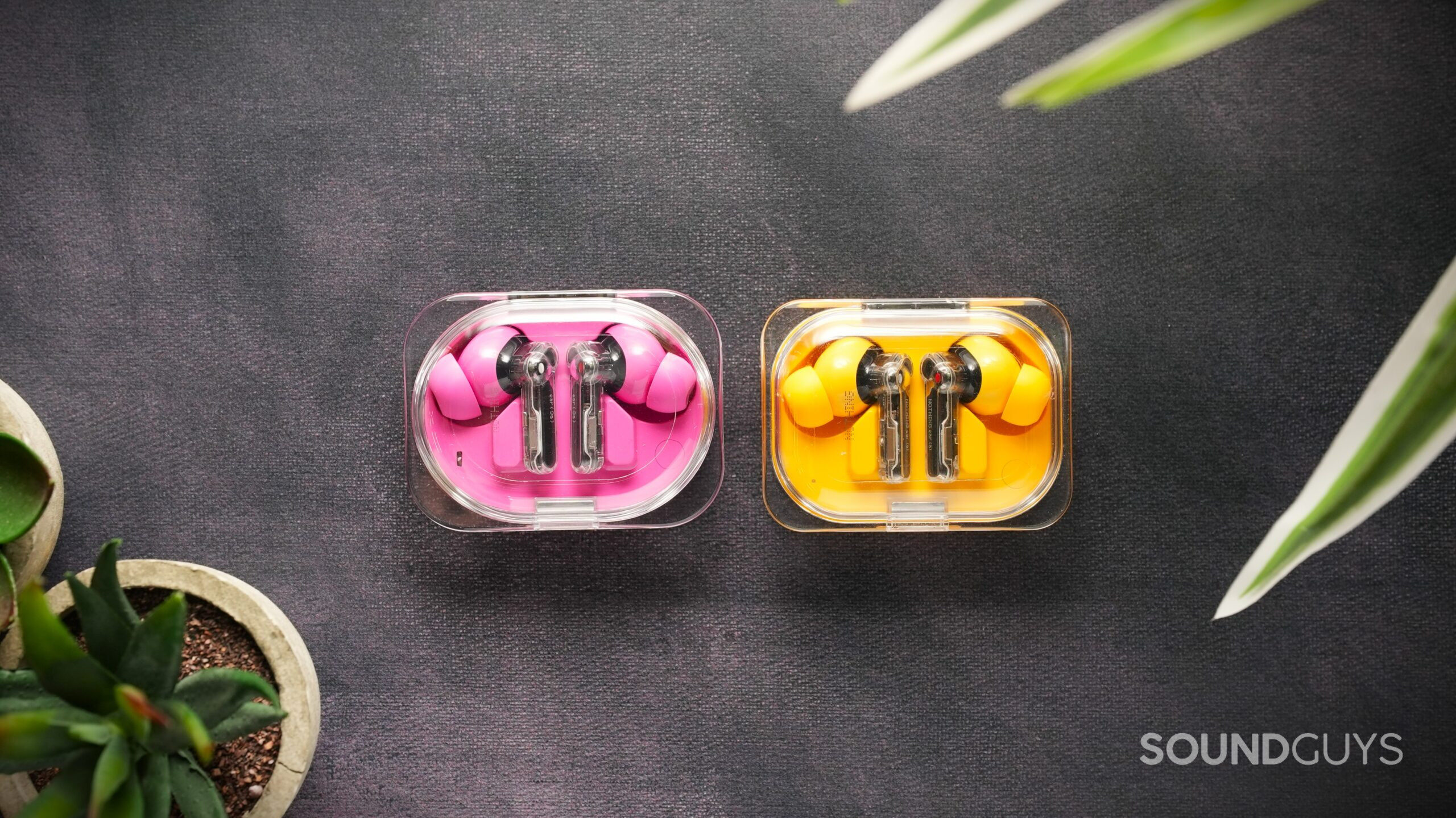 Nothing ear 3a vs Ear a Nothing ear 3a in pink vs Ear a in yellow, earbuds on surface