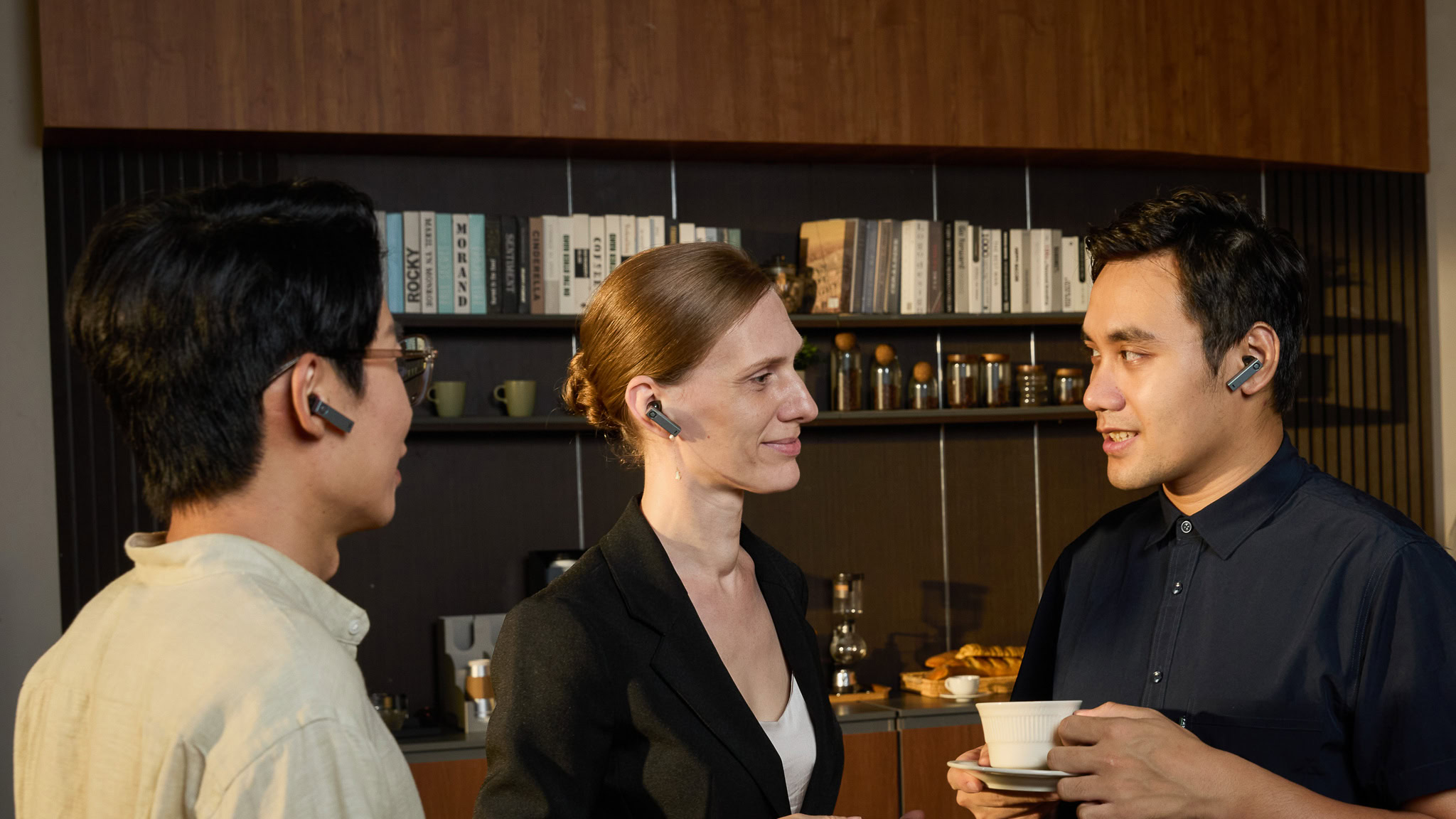 Timekettle X1 in a casual meeting Timekettle earbuds used in a conversation with three people