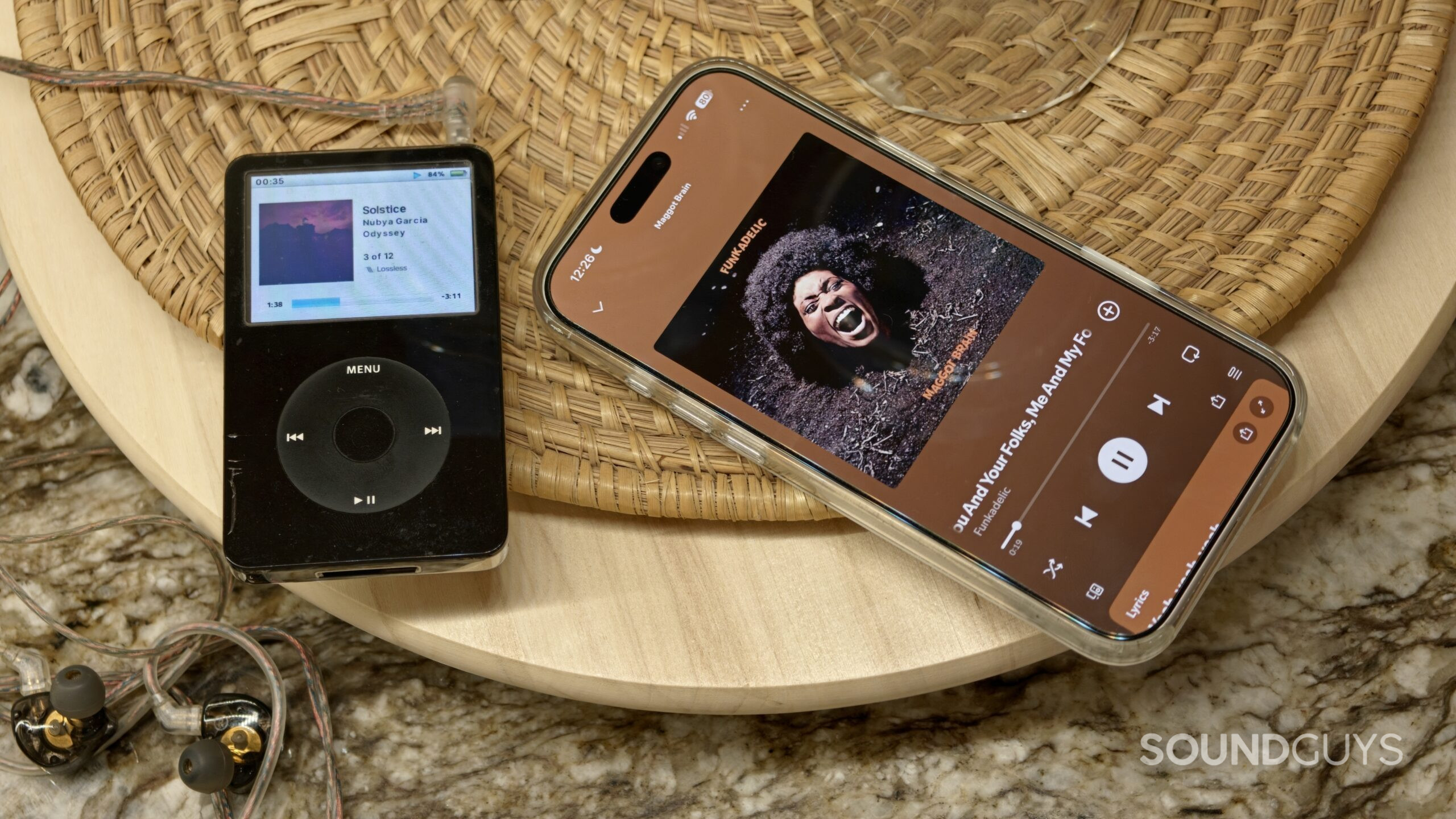 iPod placed next to an iPhone with Spotify