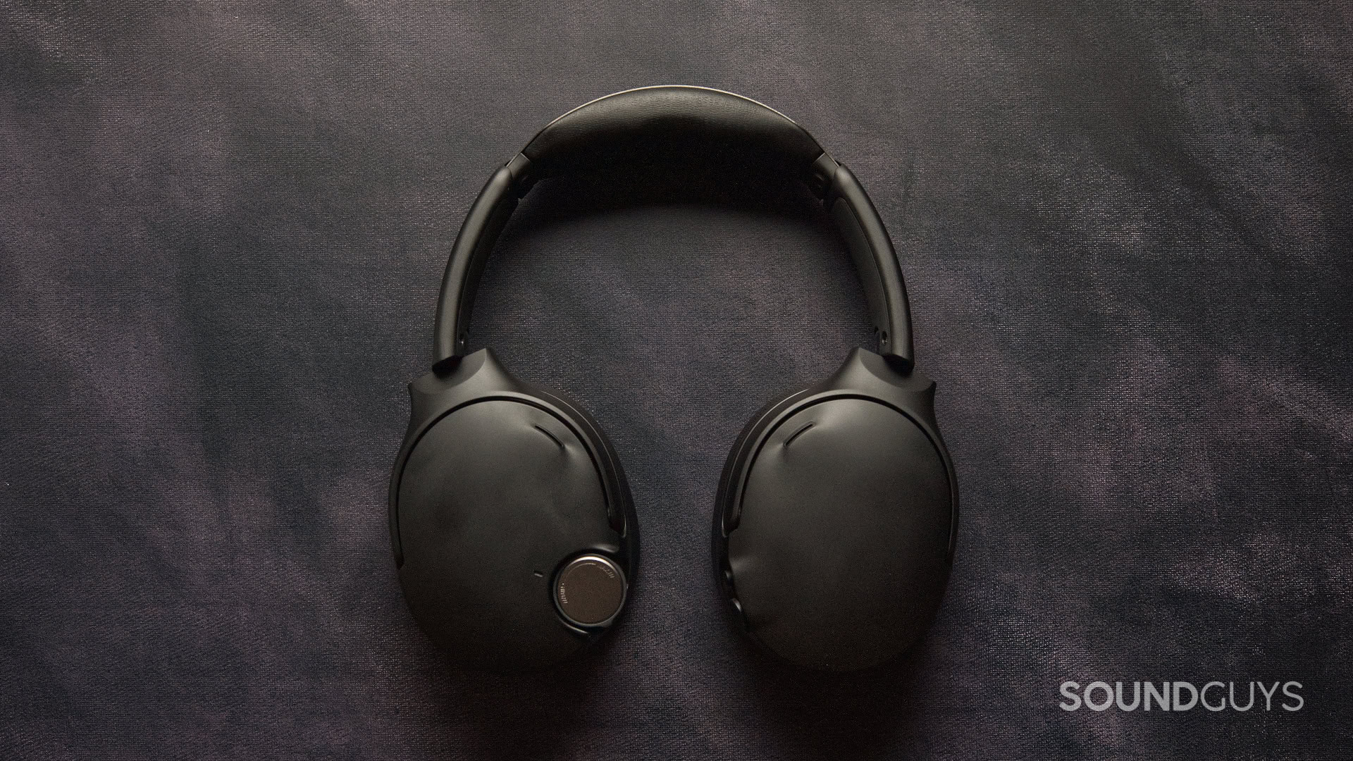 A top-down photo of the Skullcandy Crusher 1080 ANC on a dark patterned background.