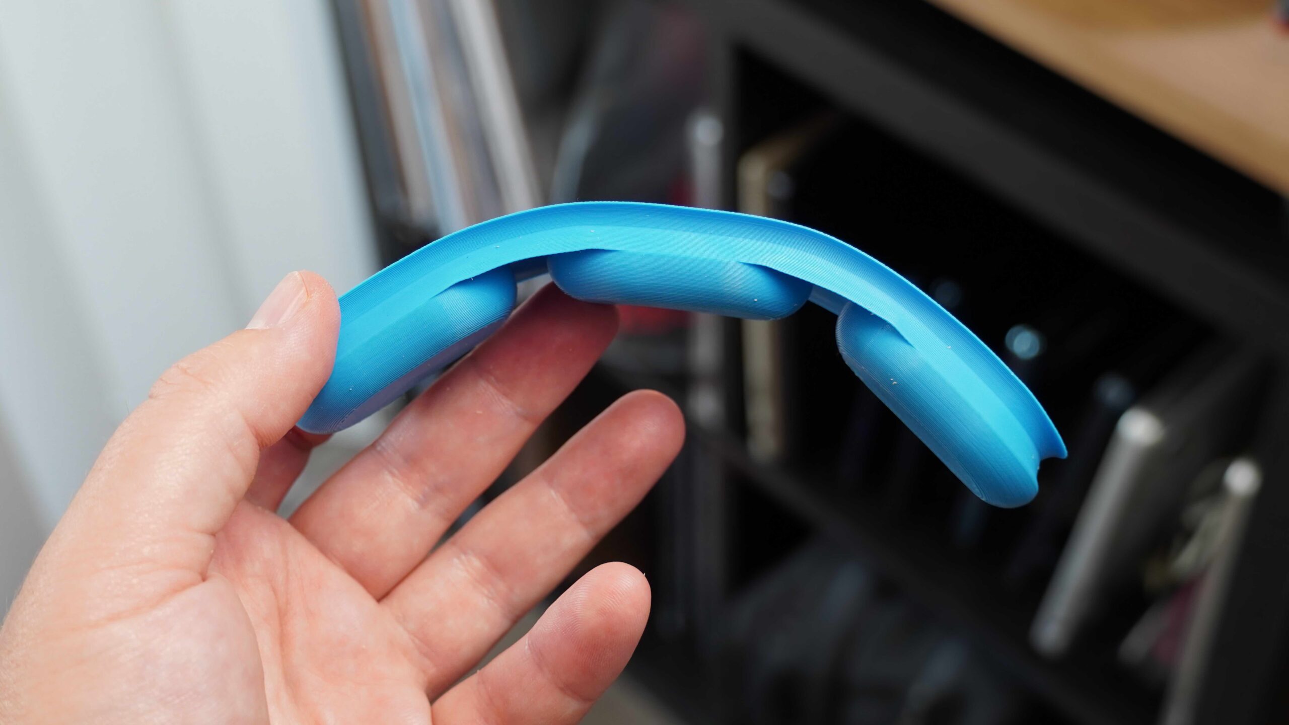 The TPU insert for the AirPods Max in the hand.