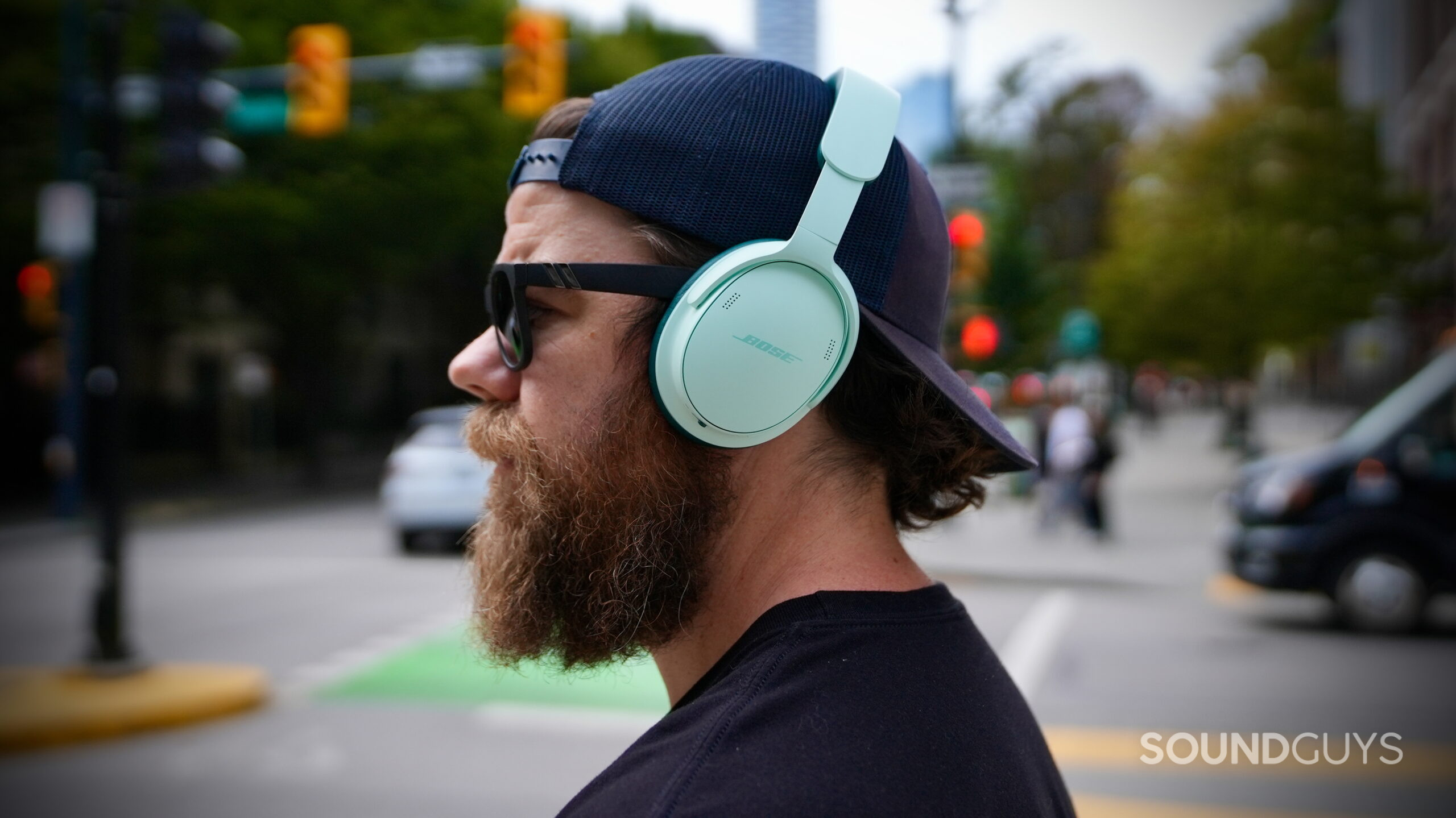 Bose QC Headphones (2nd Gen) - 7 The Bose QuietComfort Headphones (2nd Gen) worn outdoors on a city street.