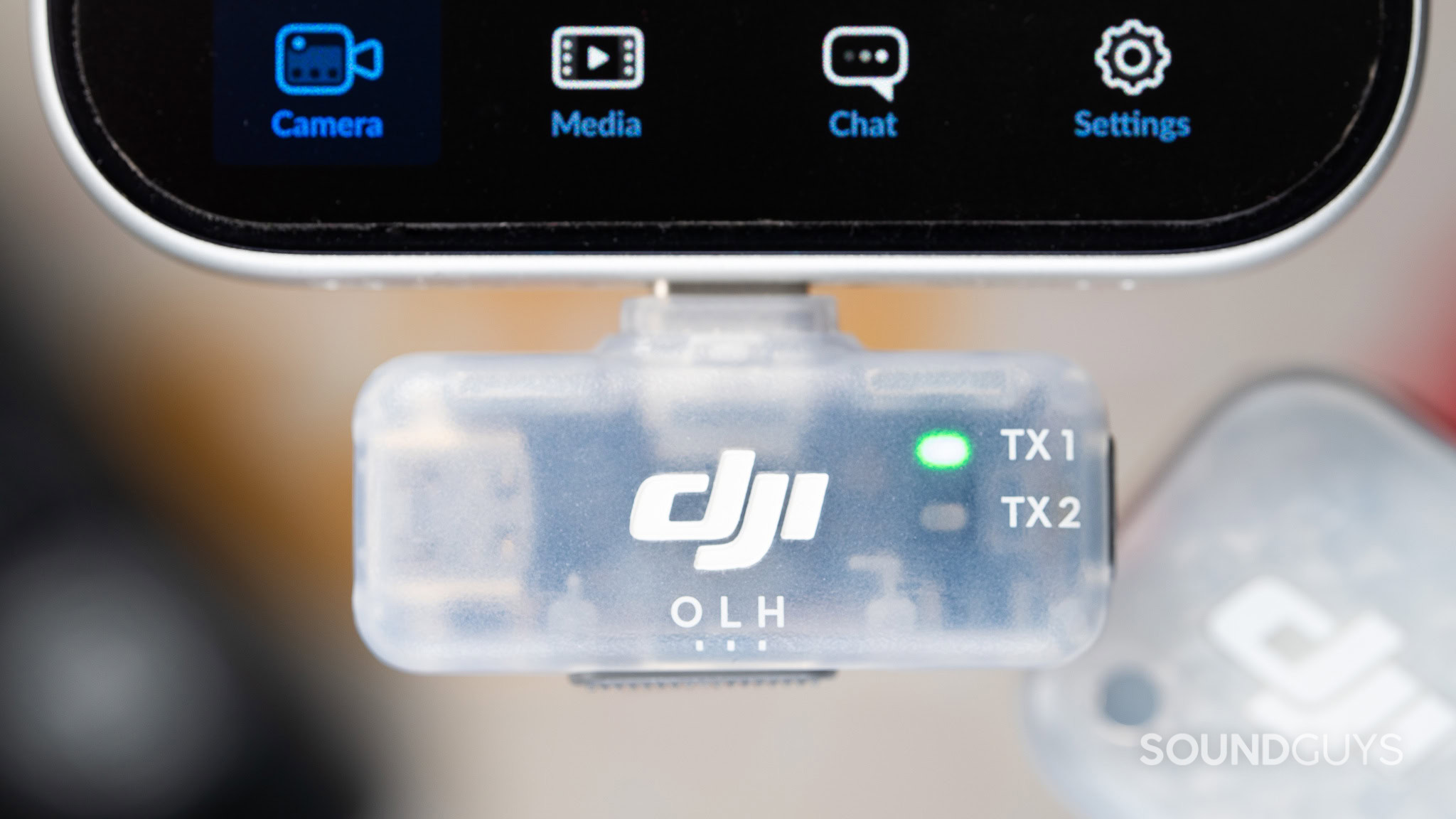 DJI Mic Mini 2S Mobile transmitter close up DJI Mic Mini 2S Mobile transmitter close up, showing two transmitter connection LEDs and legends for a toggle switch.