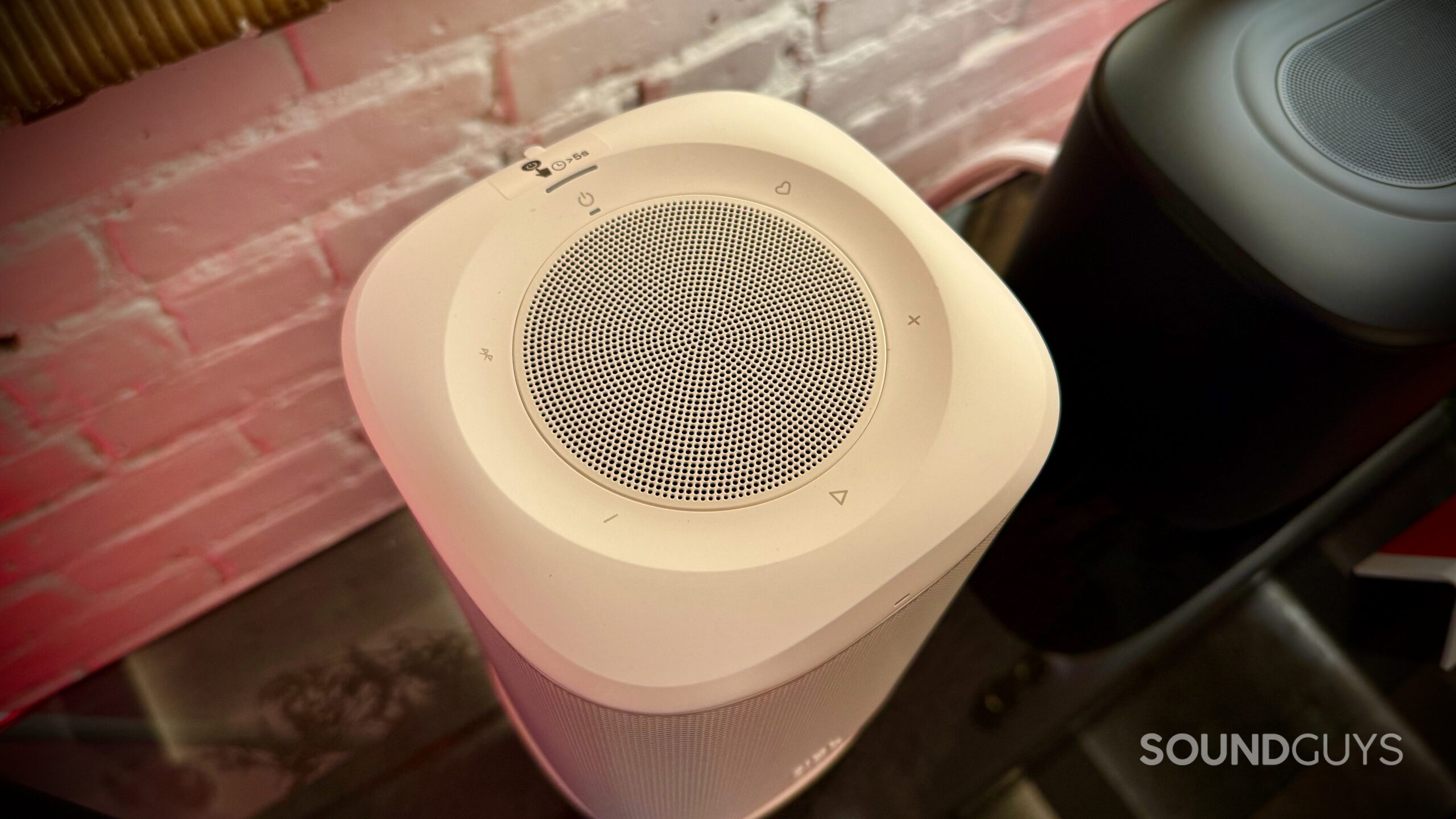 White JBL Cove P1 viewed from above, showing its up-firing tweeter and top controls.