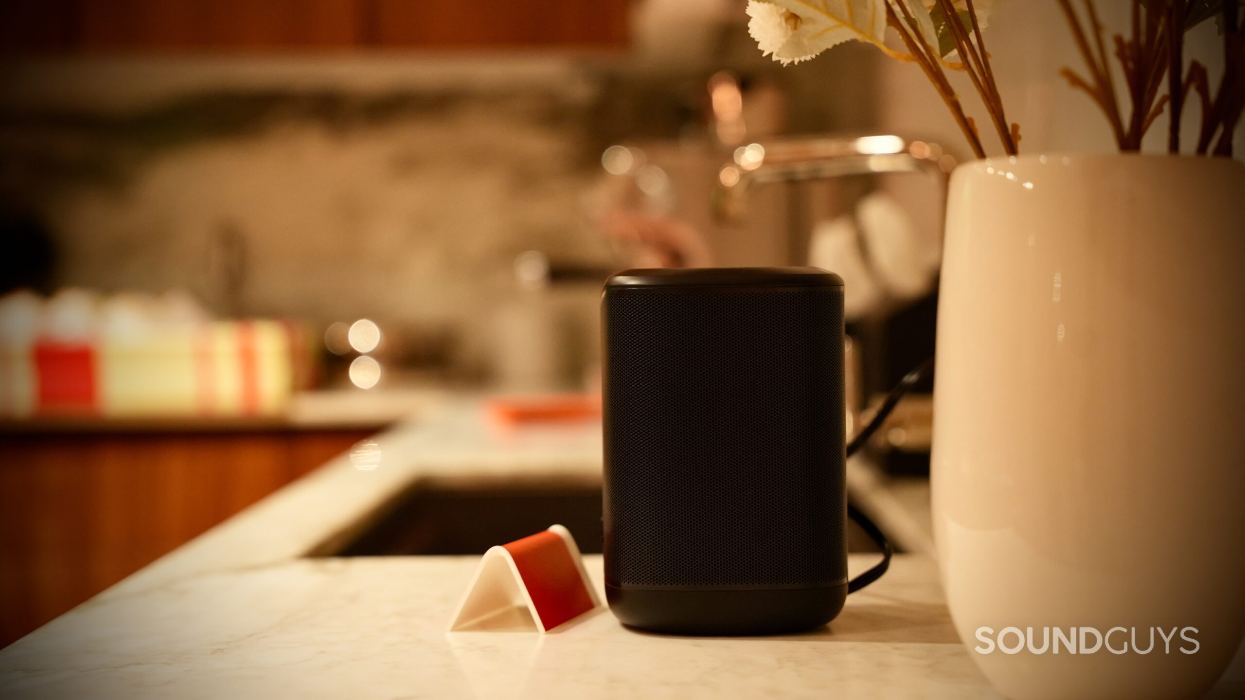 JBL Cove Series - 7 Black JBL Cove M1 Wi-Fi speaker sitting on a kitchen counter.