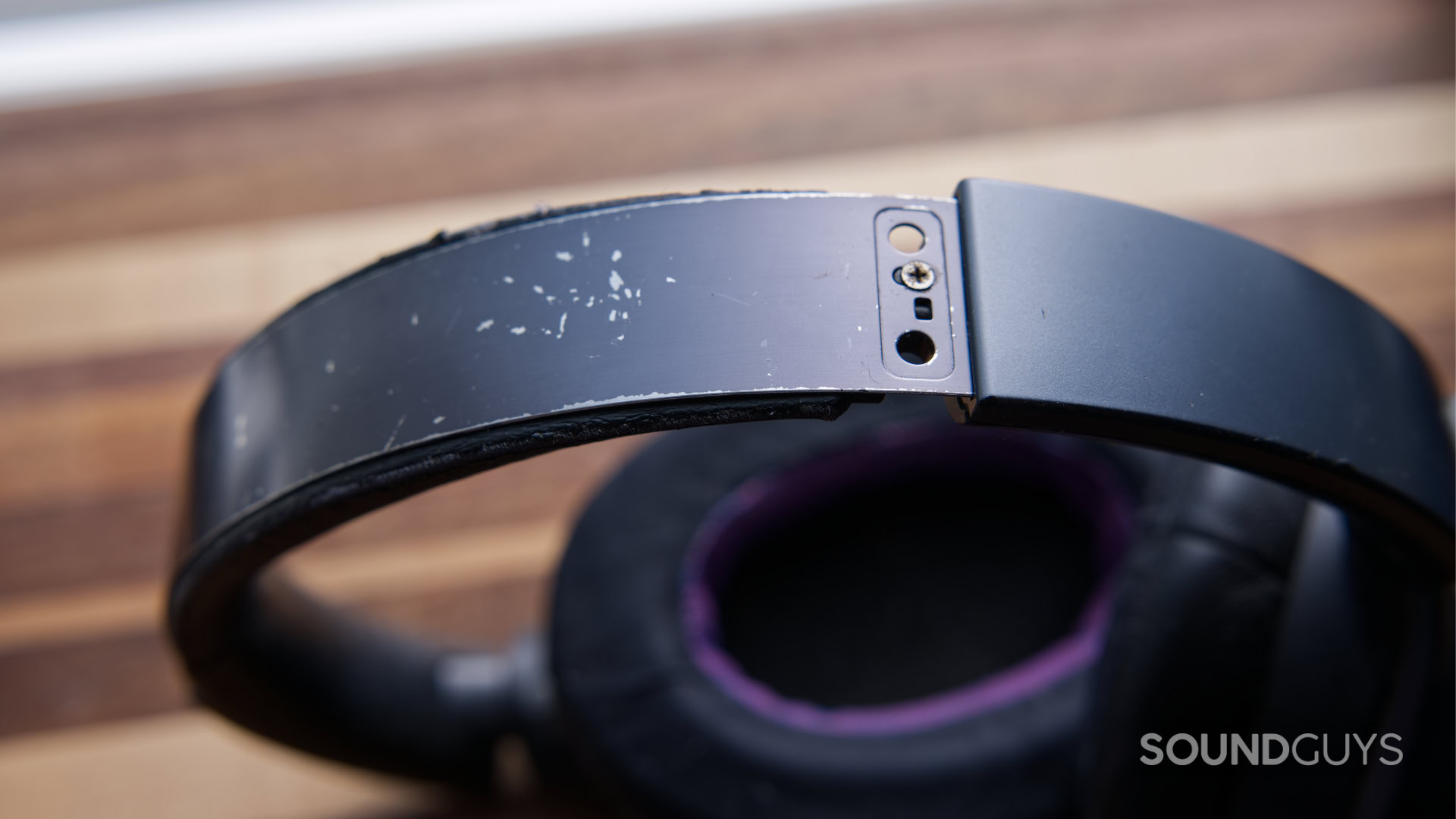 A photo of old headphones with a broken headband.