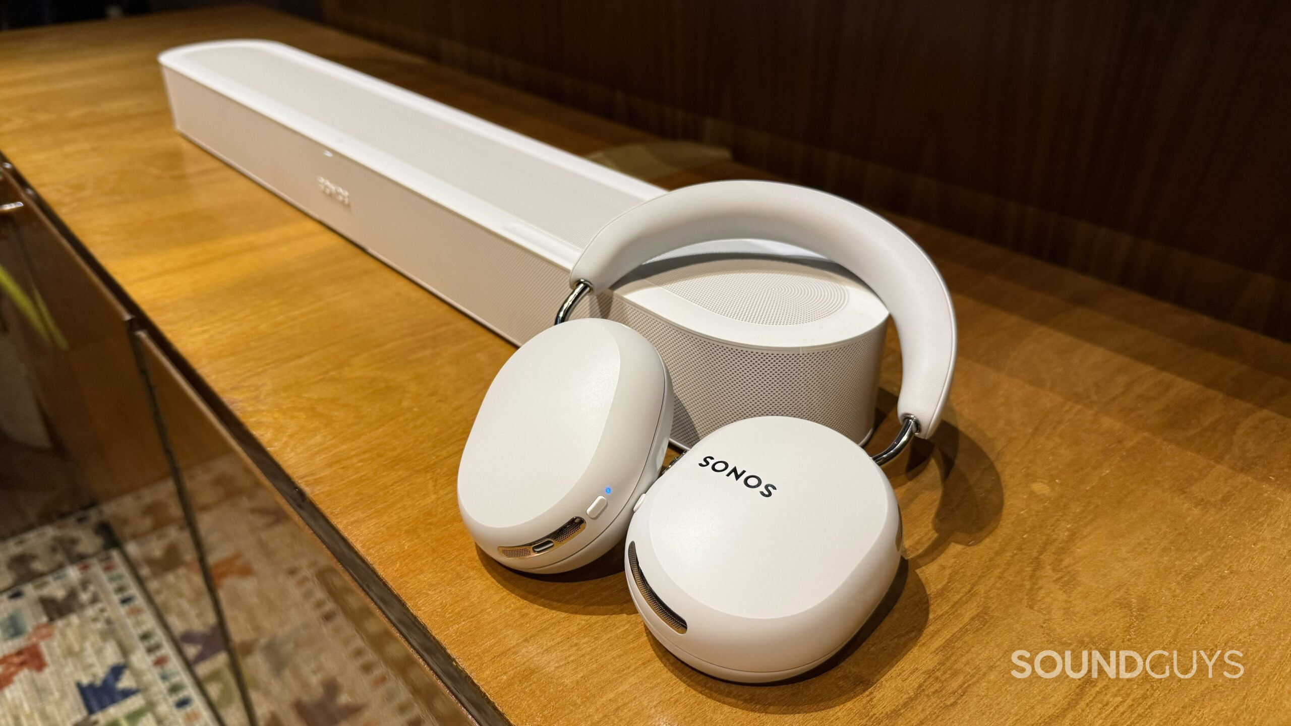 Sonos Ace Ultra headphones on Beam Ultra soundbar, white