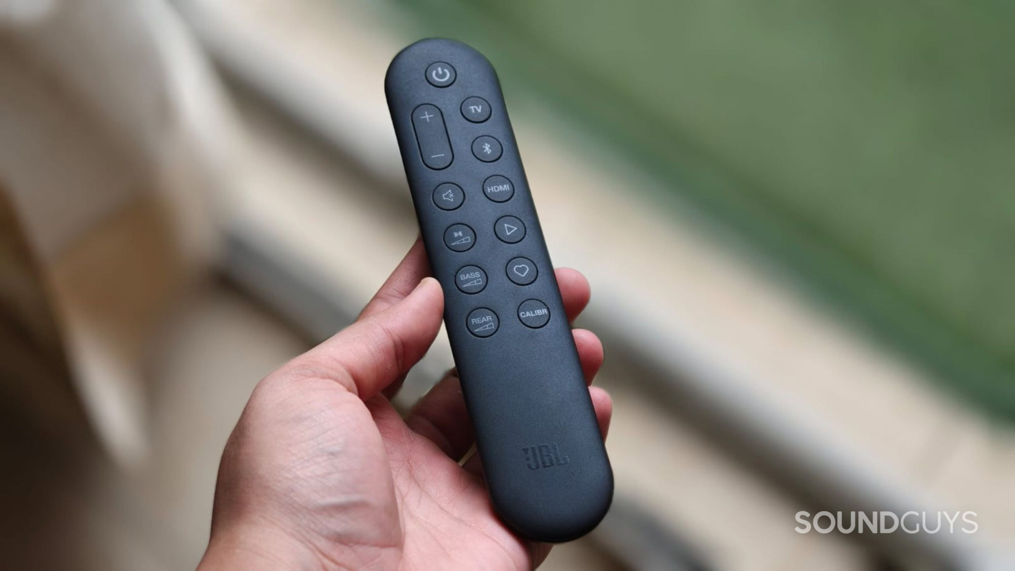 JBL Bar 1300MK2 remote in a person's hand