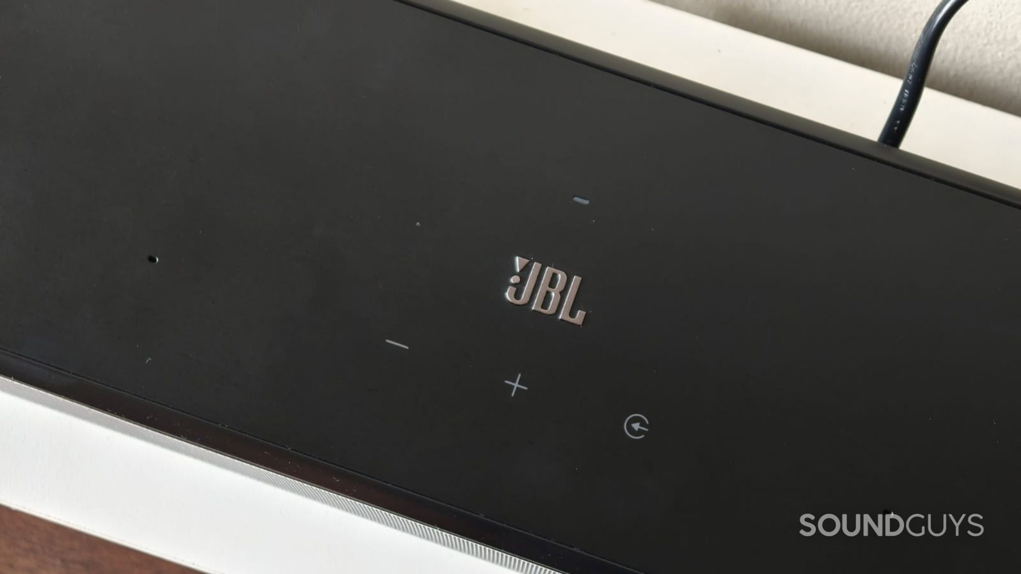 The JBL symbol with volume controls on the JBL Bar 1300MK2