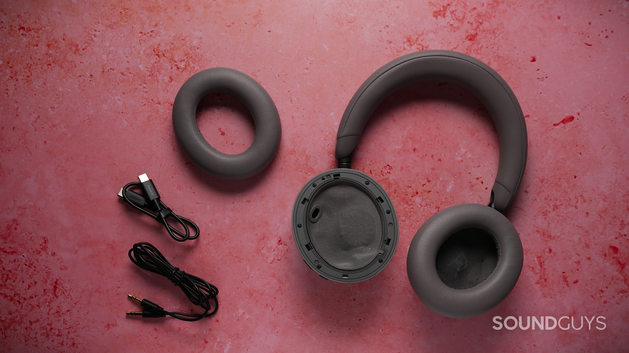 soundcore space 2 pro Gray Soundcore Space 2 Pro headphones with one ear pad removed, alongside the ear pad, USB-C cable, and 3.5mm audio cable.