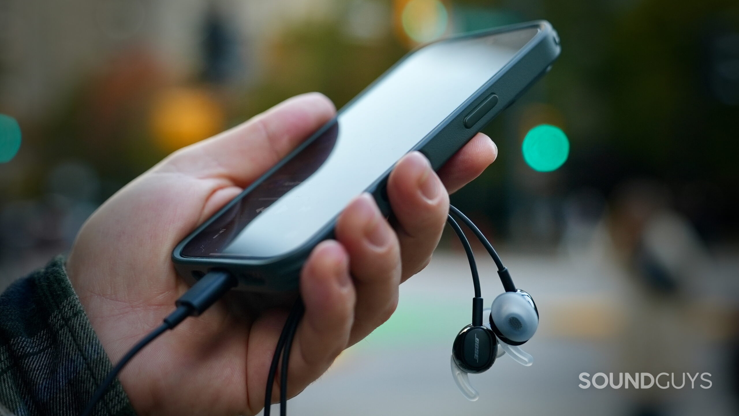 Bose Noise Canceling Wired Earbuds - 3 Smartphone connected to Bose USB-C earbuds, with the earbuds hanging below it.