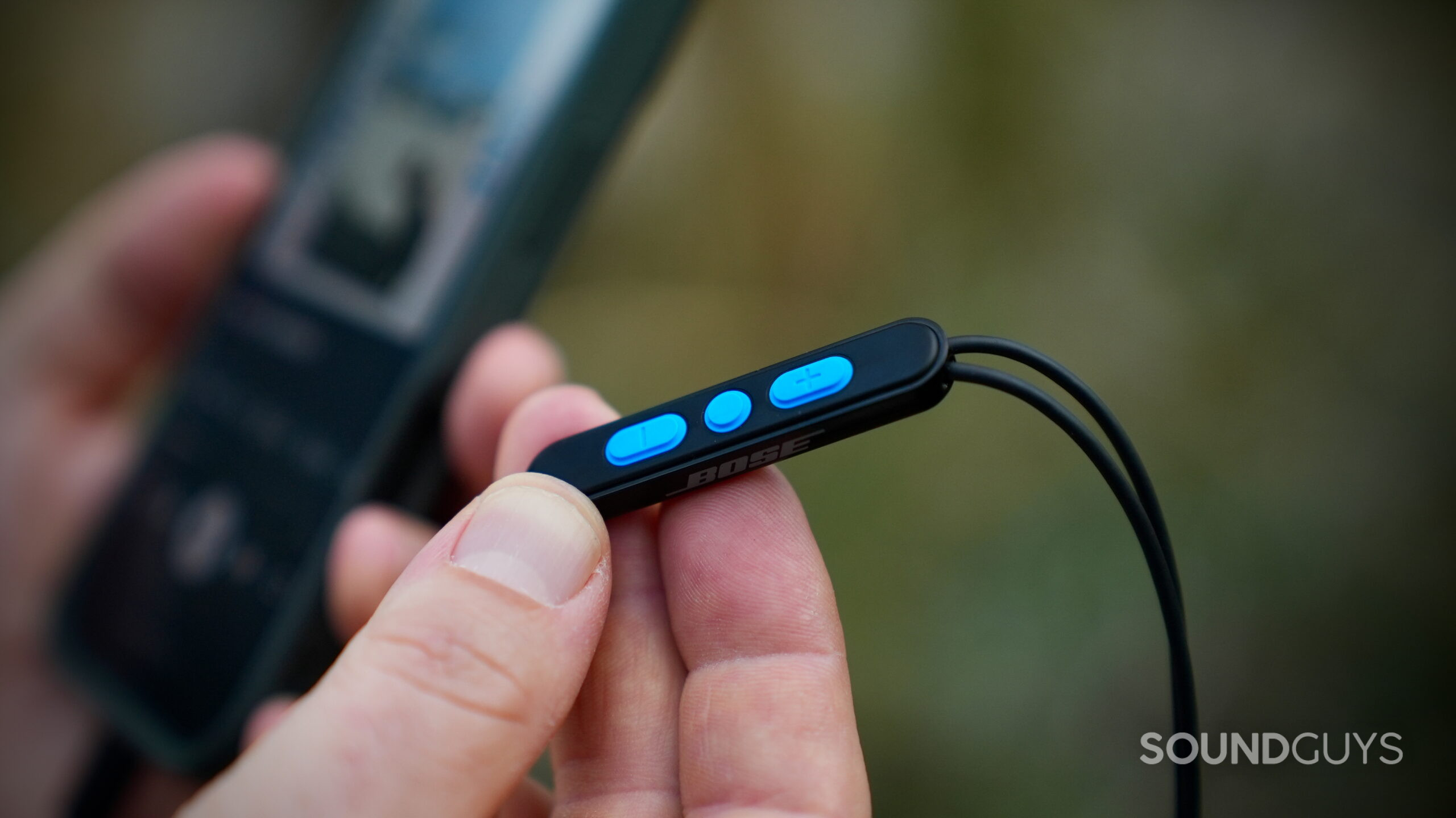 Bose Noise Canceling Wired Earbuds - 4 Close-up of the Bose inline remote with three blue control buttons.