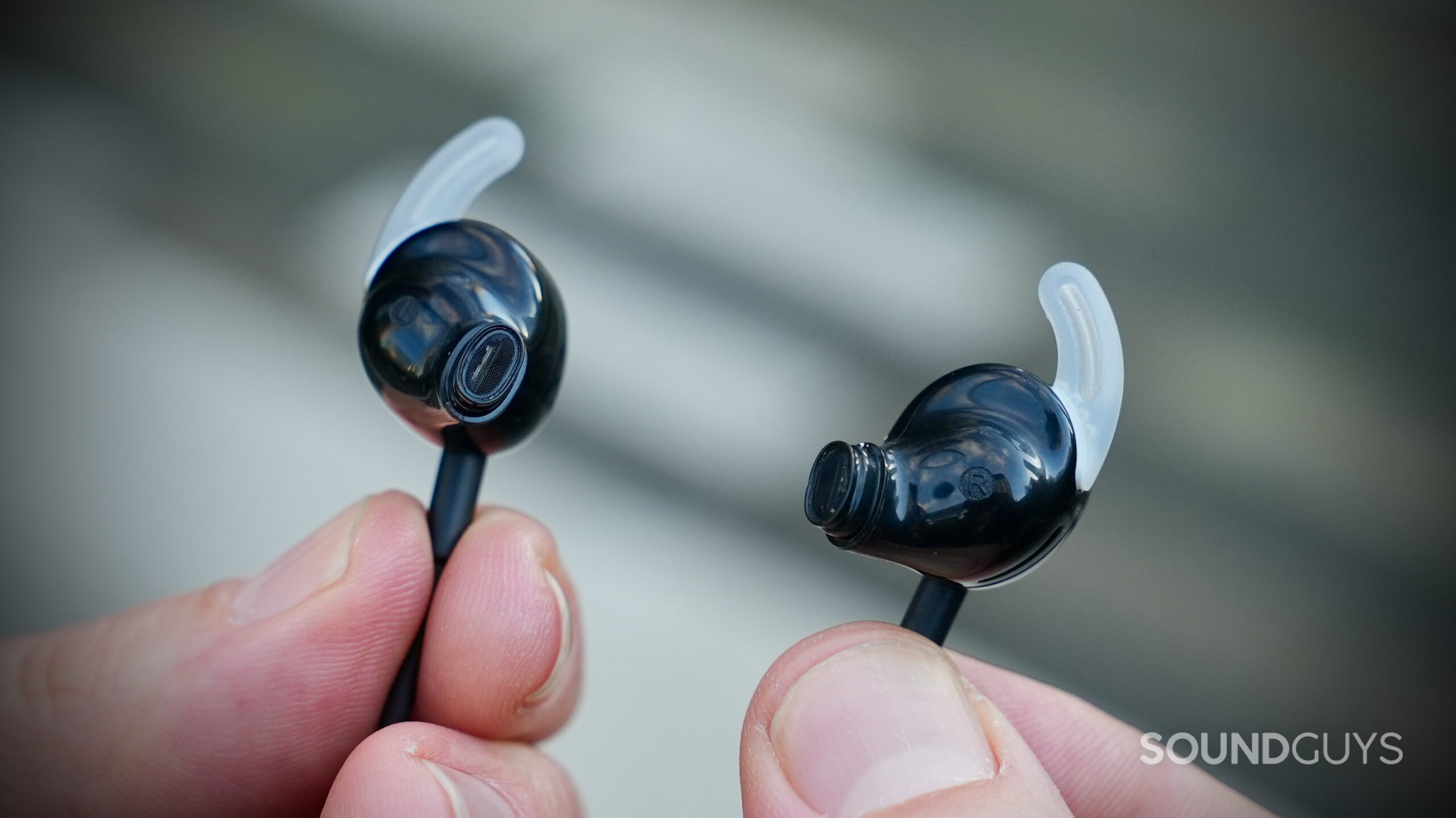 Close-up of the Bose earbuds showing the silicone tips and stabilizer wings.