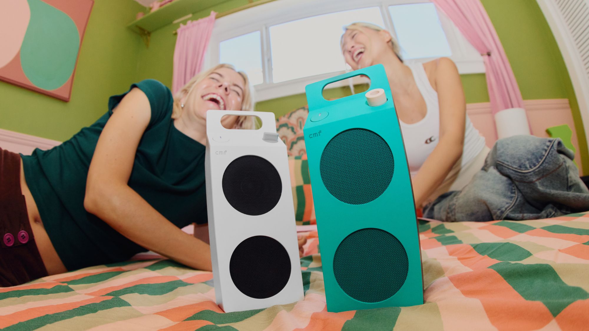 CMF Speaker M on bed with people on the side