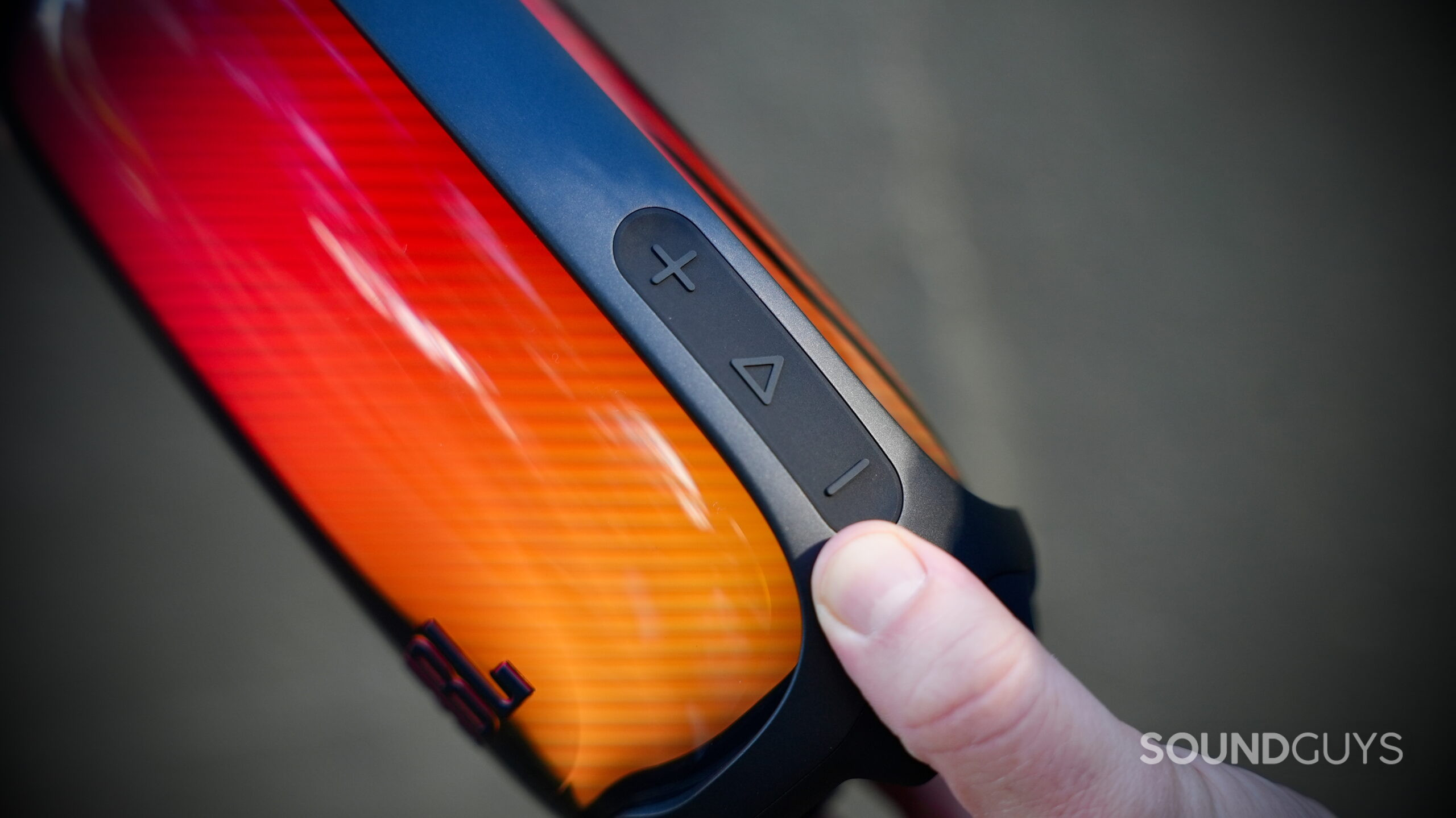 Close-up of the JBL Pulse 6's volume and playback buttons beside its illuminated housing.