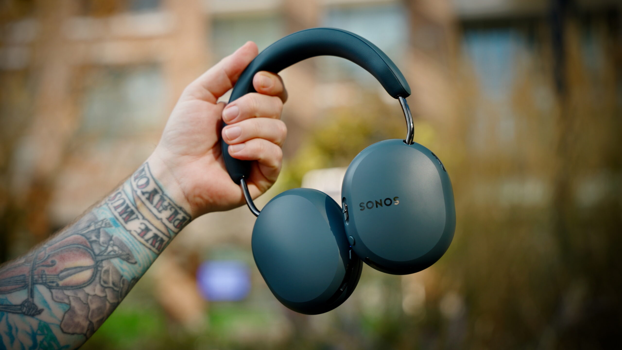 Sonos Ace Ultra stills - 2 Blue Agave Sonos Ace Ultra headphones being held outdoors