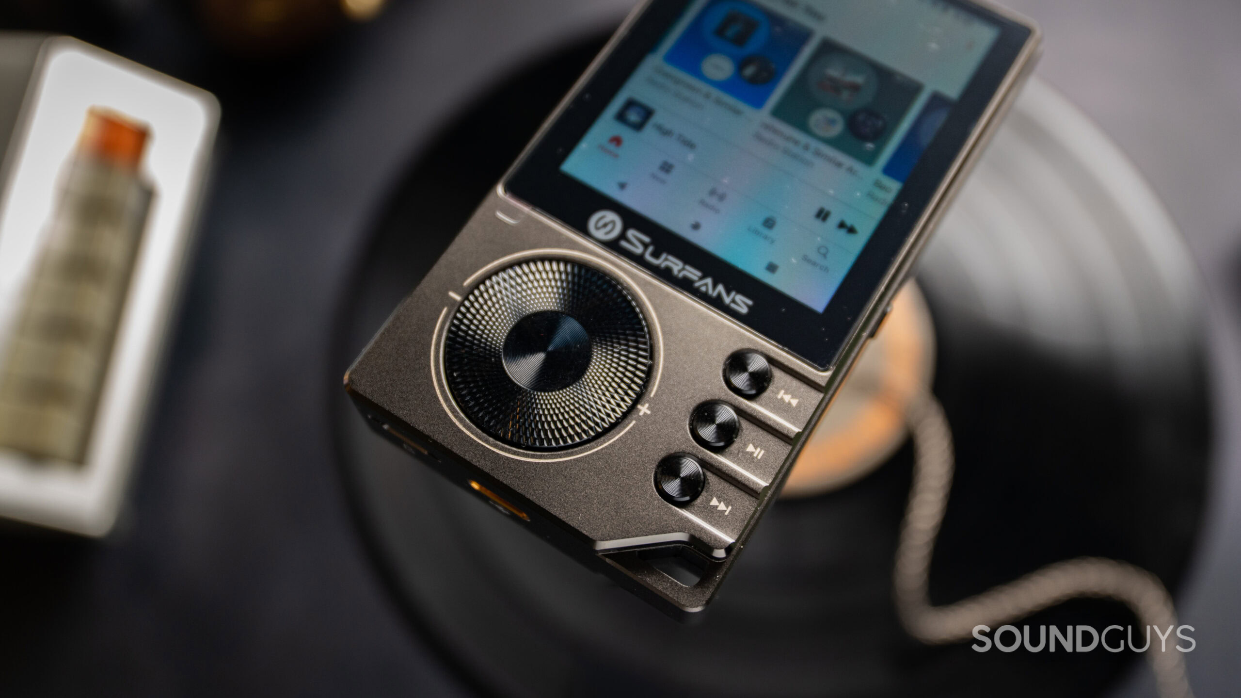 Surfans F20 Pro+ Buttons close up The Surfans F20 Pro+ with the buttons close up and an app in the background.