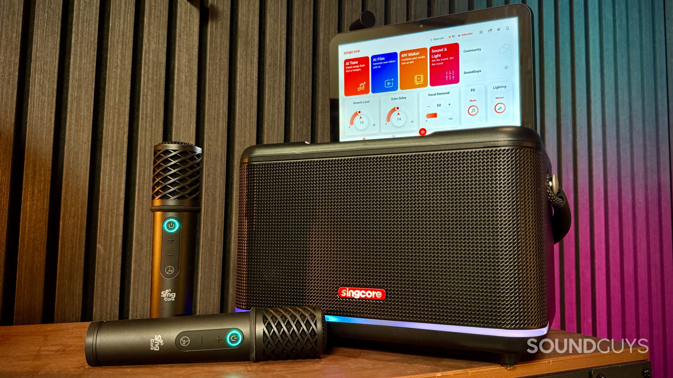 Singcore S1 Pro karaoke speaker with its touchscreen raised and two wireless microphones in front.